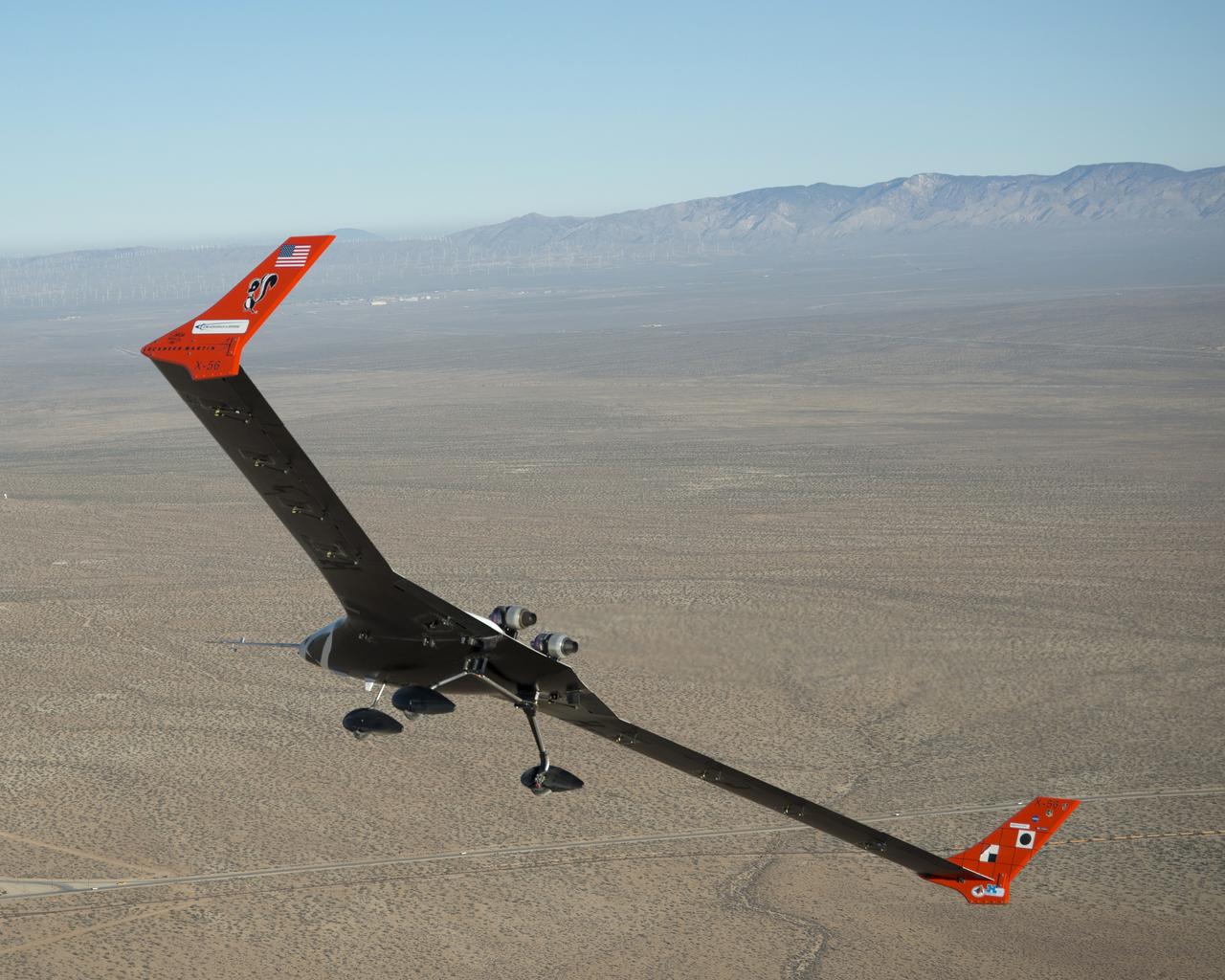 The X-56A flies over the desert near NASA Armstrong Flight Research Center, Edwards, California.  NASA researchers are using the remotely piloted X-56A to explore the behavior of lightweight, flexible aircraft structures.