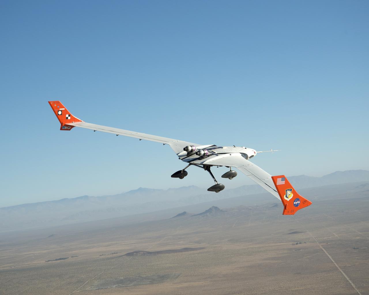The X-56A flies over the desert near NASA Armstrong Flight Research Center, Edwards, California.  NASA researchers are using the remotely piloted X-56A to explore the behavior of lightweight, flexible aircraft structures.