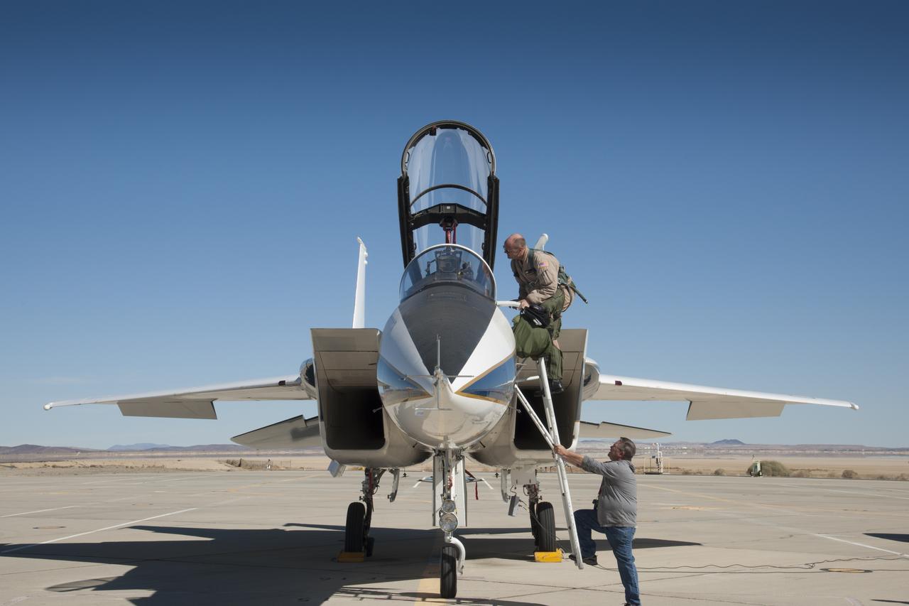 After climbing the stairs, NASA pilot Nils Larson sits in a NASA F-15B aircraft and begins preflight procedures.