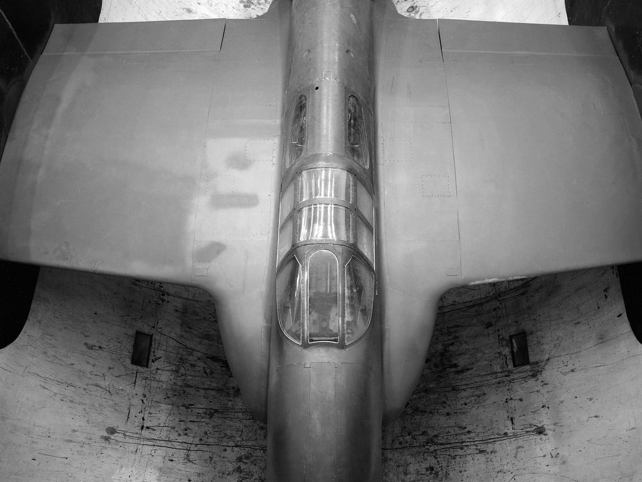The secret test of the Bell YP–59A Airacomet in the spring of 1944 was the first investigation in the National Advisory Committee for Aeronautics (NACA) Aircraft Engine Research Laboratory’s new Altitude Wind Tunnel (AWT). The Airacomet, powered by two General Electric I–A centrifugal turbojets, was the first US jet aircraft. The Airacomet’s 290-miles per hour speed, however, was dwarfed by the German Messerschmitt Me-262 Schwalbe’s 540 miles per hour.  In 1941 and 1942 General Electric built the first US jet engines based on technical drawings from British engineer Frank Whittle. Bell Aircraft was contracted to produce an airframe to incorporate the new engines. The result was the Bell XP–59A Airacomet. The aircraft made its first flight over Muroc Lake, California, on October 2, 1942. The aircraft continued to struggle over the next year and the NACA was asked to test it in the new AWT.    A Bell YP–59A was flown from the Bell plant in Buffalo to Cleveland by Bob Stanley, who had piloted the first successful flight of the XP–59A at Muroc in 1942. The wing tips and tail were cut from the aircraft so that it would fit into the AWT’s test section. The study first analyzed the engines in their original configuration and then implemented a boundary layer removal duct, a new nacelle inlet, and new cooling seals. Tests of the modified version showed that the improved airflow distribution increased the I–16’s performance by 25 percent. Despite the improved speed, the aircraft was not stable enough to be used in combat, and the design was soon abandoned.