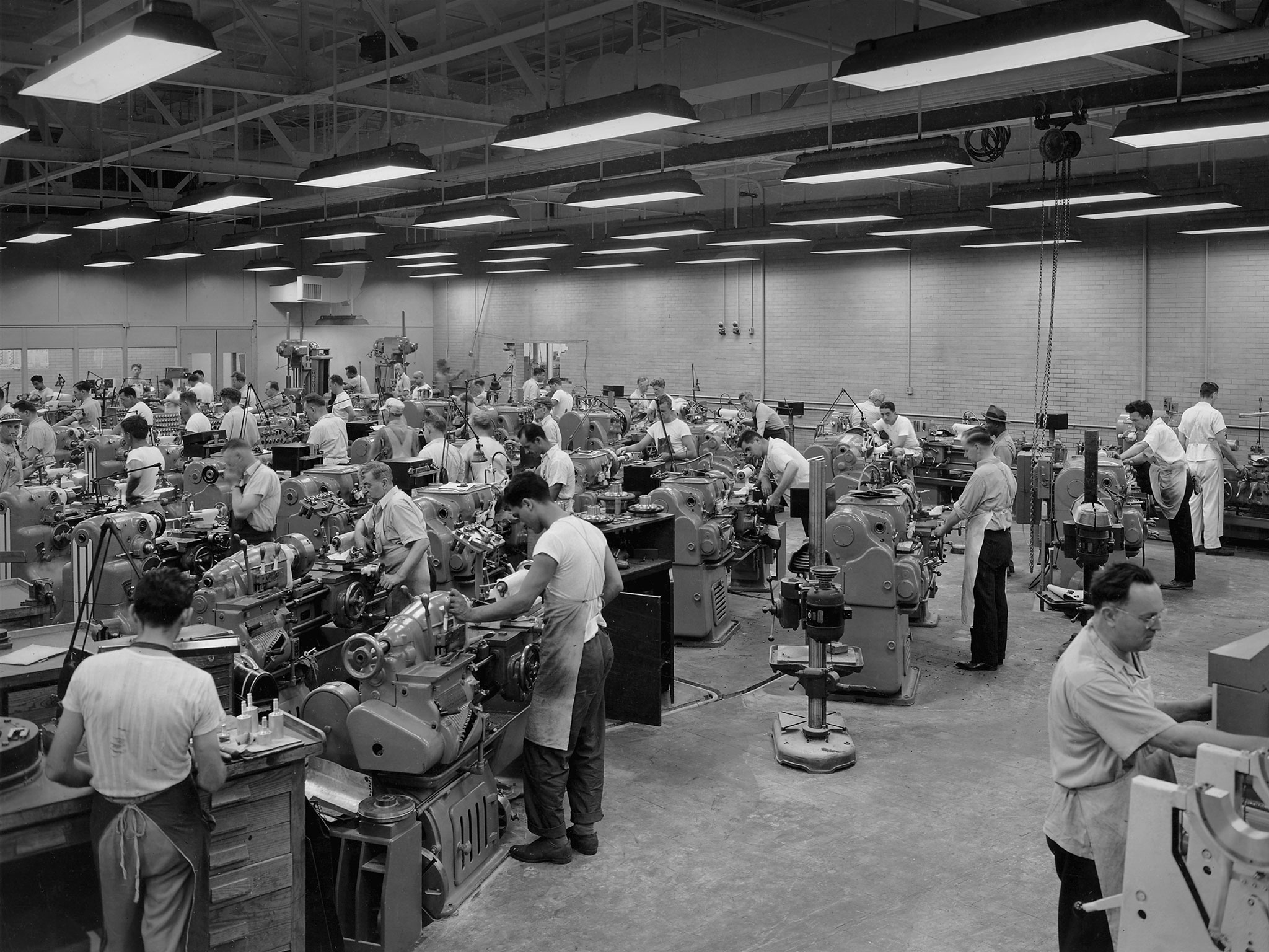 A view of the machine shop at the NACA's Lewis Flight Propulsions Laboratory in the 1940s, with numerous technicians working.