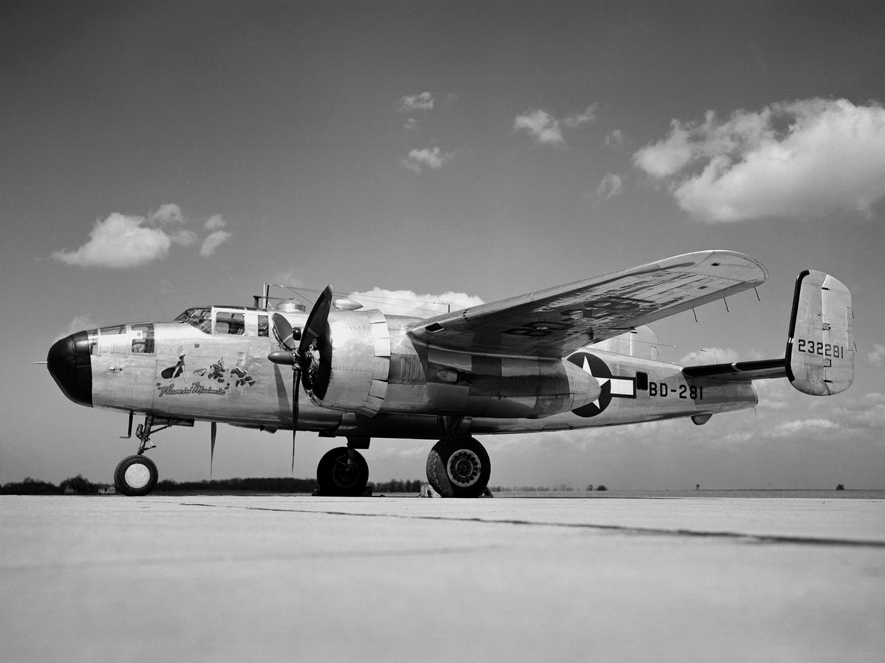 In 1946 the Lewis Flight Propulsion Laboratory became the NACA’s official icing research center. In addition to the Icing Research Tunnel, the lab possessed several aircraft modified for icing work, including a Consolidated B-24M Liberator and a North American XB-25E Mitchell, seen here. The XB-25E’s frequent engine fires allegedly resulted in its “Flamin’ Maimie” nickname. The aircraft’s nose art, visible in this photograph, includes a leather-jacketed mechanic with an extinguisher fleeing a fiery woman.   North American developed the B-25 in the mid-1930s as a transport aircraft, but it was hurriedly reconfigured as a medium bomber for World War II. This XB-25E was a single prototype designed in 1942 specifically to test an exhaust gas ice prevention system developed by NACA researcher Lewis Rodert.  The system circulated the engines’ hot bleed air to the wings, windshield, and tail. The XB-25E was utilized at the NACA’s Ames Aeronautical Laboratory for two years before being transferred to Cleveland in July 1944.  NACA Lewis mechanics modified the aircraft further by installing electrical heating in the front fuselage, propellers, inboard sing, cowls, and antennae.    Lewis pilots flew the B-24M and XB-25E into perilous weather conditions all across the country to study both deicing technologies and the physics of ice-producing clouds. These dangerous flights led to advances in weather sensing instruments and flight planning.