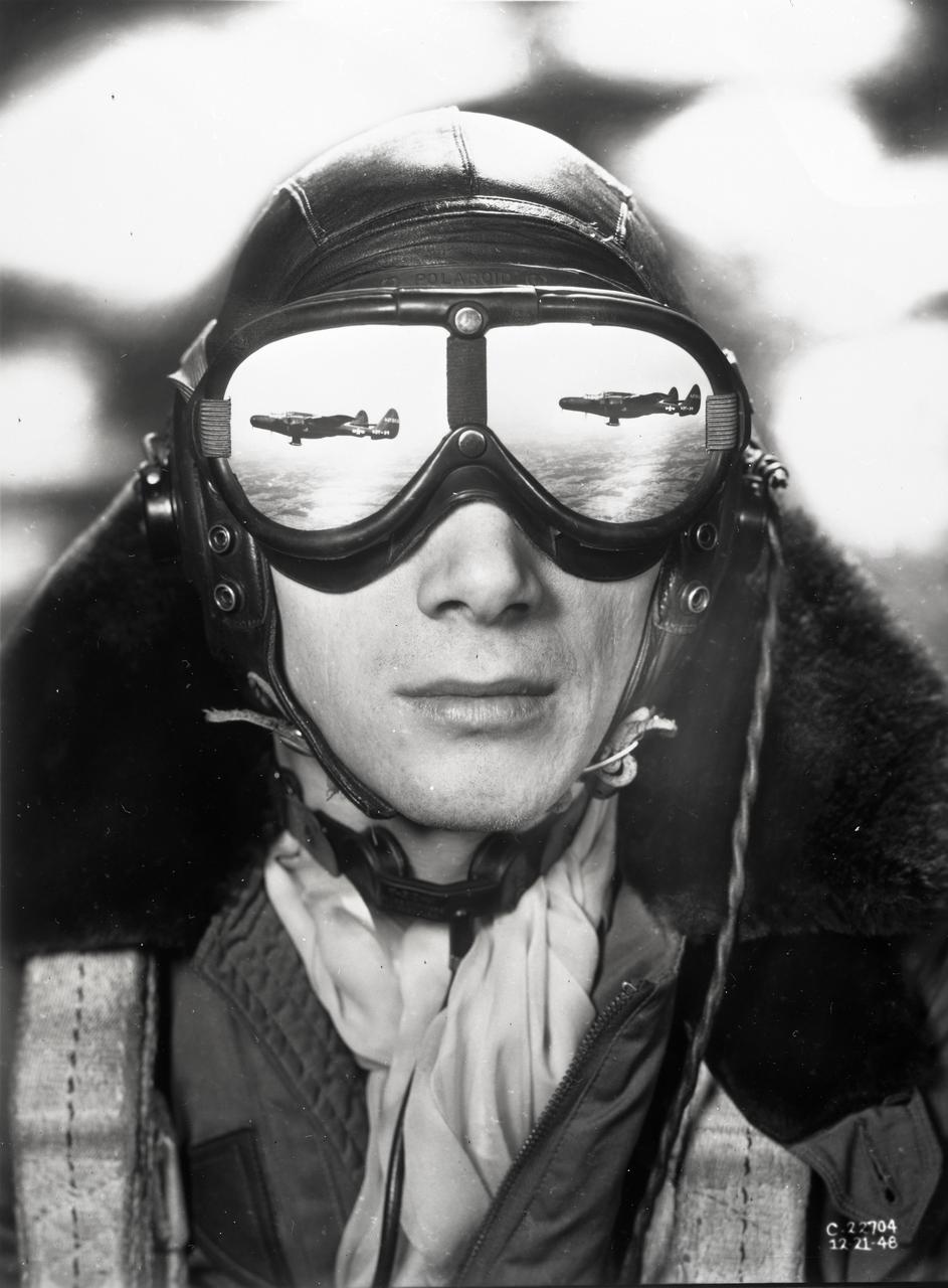 Flight engineer and photographer William Wynne (pictured) worked with photographer Arthur Laufman to execute a photo concept devised by Laufman.  Wynne printed two copies of the F-61 aircraft in flight.  The prints were made to the correct size that allowed them to be cut out and taped to the lenses of his goggles to simulate a reflection.  The photo of Wynne was then taken with an out of focus background to simulate clouds.