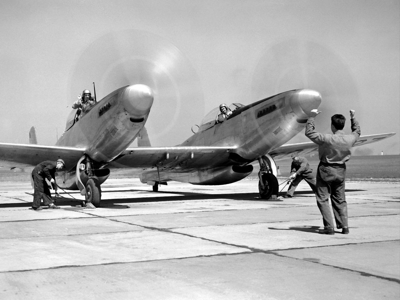Pilot William Swann, right cockpit, prepares the North American XF-82 Twin Mustang for flight at the National Advisory Committee for Aeronautics (NACA) Lewis Flight Propulsion Laboratory. The aircraft was one of only two prototypes built by North American in October 1945 and powered by Packard Merlin V-1650 piston engines. Over 270 of the F-82 long-distance pursuit fighters were produced during the 1940s. The Mustang’s unique two-pilot configuration allowed one pilot to rest during the long missions and thus be ready for action upon arrival. The NACA took possession of this XF-82 in October 1947.    NACA Lewis used the XF-82 as a test bed for ramjet flight tests. Ramjets are continually burning tubes that use the compressed atmospheric air to produce thrust. Ramjets are extremely efficient at high speeds, but rely on some sort of booster to attain that high speed. NACA Lewis undertook an extensive ramjet program in the 1940s that included combustion studies in the Altitude Wind Tunnel, a number of flight tests, and missile drops from aircraft.    The 16-inch diameter ramjet missile was fixed to the XF-82 Mustang’s wing and dropped from high altitudes off of Wallops Island. The tests determined the ramjet’s performance and operational characteristics in the transonic range.