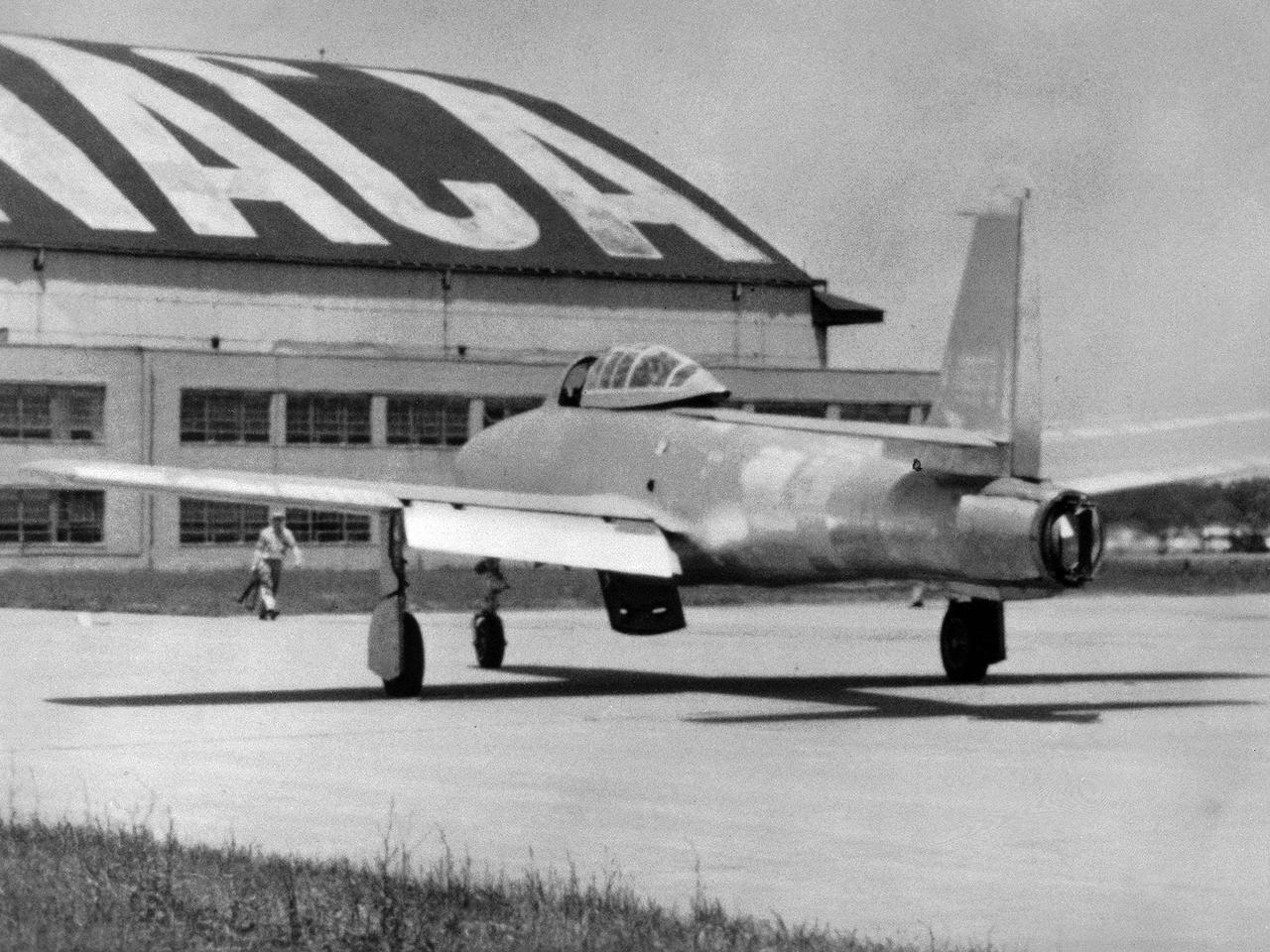 The US Air Force loaned a Republic F-84 Thunderjet to the National Advisory Committee for Aeronautics (NACA) Lewis Flight Propulsion Laboratory in the spring of 1954. NACA researchers soon modified the aircraft for the first demonstration of a reverse thruster. Republic built over 4000 Thunderjets between 1947 and 1953 for the military as a successor to the Lockheed F-80 Shooting Star. TheF-84s became successful multi-use aircraft during the Korean War.      The use of traditional wheel brakes on high speed aircraft was problematic because the required braking system would weigh too much. The reverse thruster was developed as a method for stopping these aircraft without increasing the overall weight. Panels in the tail section near the jet engine’s nozzle opened up during a landing. These extended flaps not only caused resistance to the airstream but also reversed the engine’s thrust.     In June 1964 Irving Pinkel, head of the Lewis Physics Division, oversaw a demonstration of this technology on an F-84 at the NACA laboratory. The side fuselage panels around the engine nozzle, seen closed in this photograph, opened up like wings and deflected the engine’s thrust towards the front of the aircraft, thus producing reverse thrust. The F-84 activated the reverse thruster and the aircraft moved backwards across the runway.