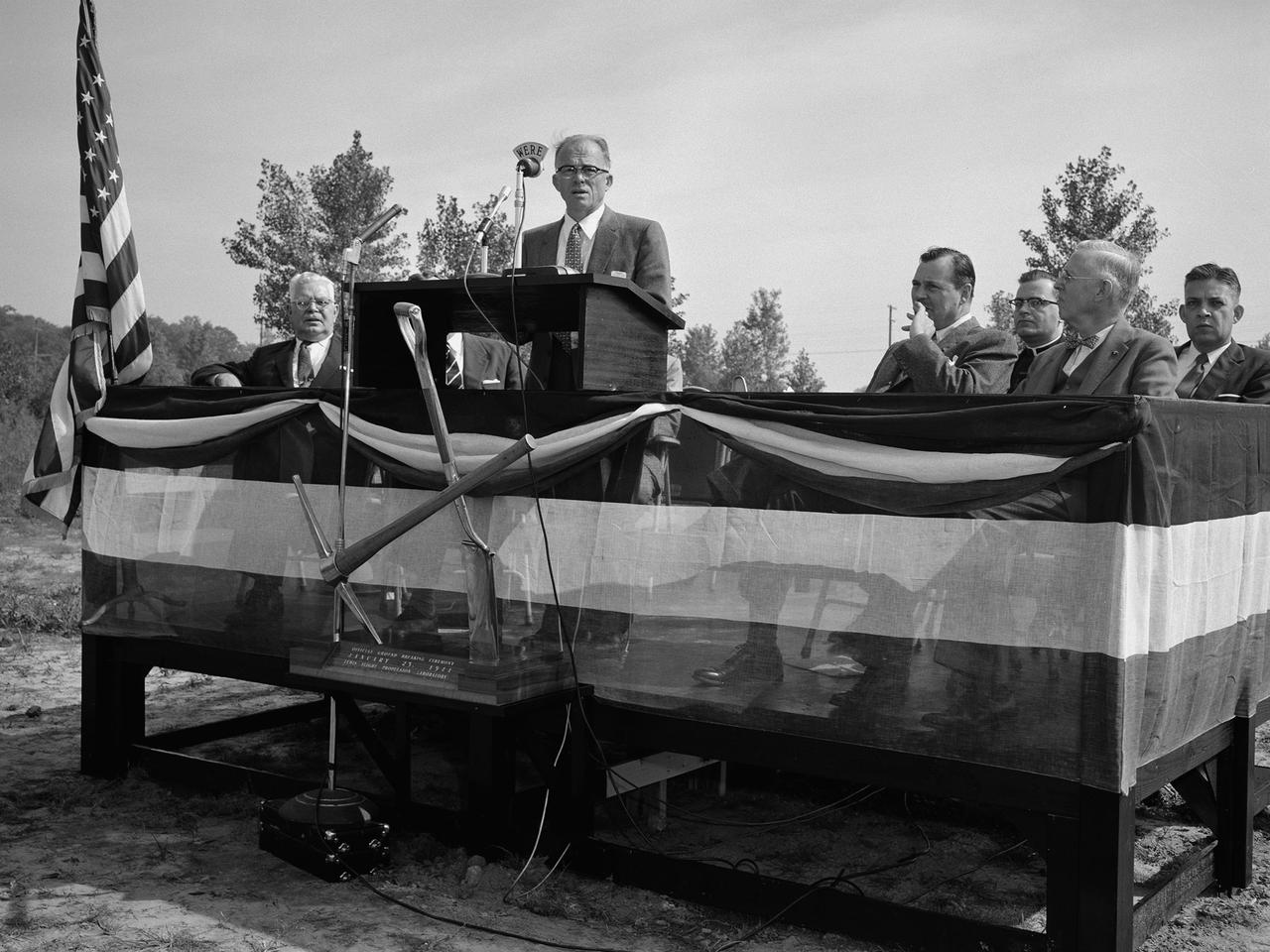 Addison Rothrock, the National Advisory Committee for Aeronautics’s (NACA) Assistant Director of Research, speaks at the groundbreaking ceremony for the Lewis Flight Propulsion Laboratory’s new test reactor at Plum Brook Station. This dedication event was held almost exactly one year after the NACA announced that it would build its $4.5 million nuclear reactor on 500 acres of the army’s 9000-acre Plum Brook Ordnance Works. The site was located in Sandusky, Ohio, approximately 60 miles west of the NACA Lewis laboratory in Cleveland. Lewis Director Raymond Sharp is seated to the left of Rothrock, Congressman Albert Baumhart and NACA Secretary John Victory are to the right. Many government and local officials were on hand for the press conference and ensuing luncheon.    In the wake of World War II the military, the Atomic Energy Commission, and the NACA became interested in the use of atomic energy for propulsion and power. A Nuclear Division was established at NACA Lewis in the early 1950s. The division’s request for a 60-megawatt research reactor was approved in 1955. The semi-remote Plum Brook location was selected over 17 other possible sites.    Construction of the Plum Brook Reactor Facility lasted five years. By the time of its first trial runs in 1961 the aircraft nuclear propulsion program had been cancelled. The space age had arrived, however, and the reactor would be used to study materials for a nuclear powered rocket.