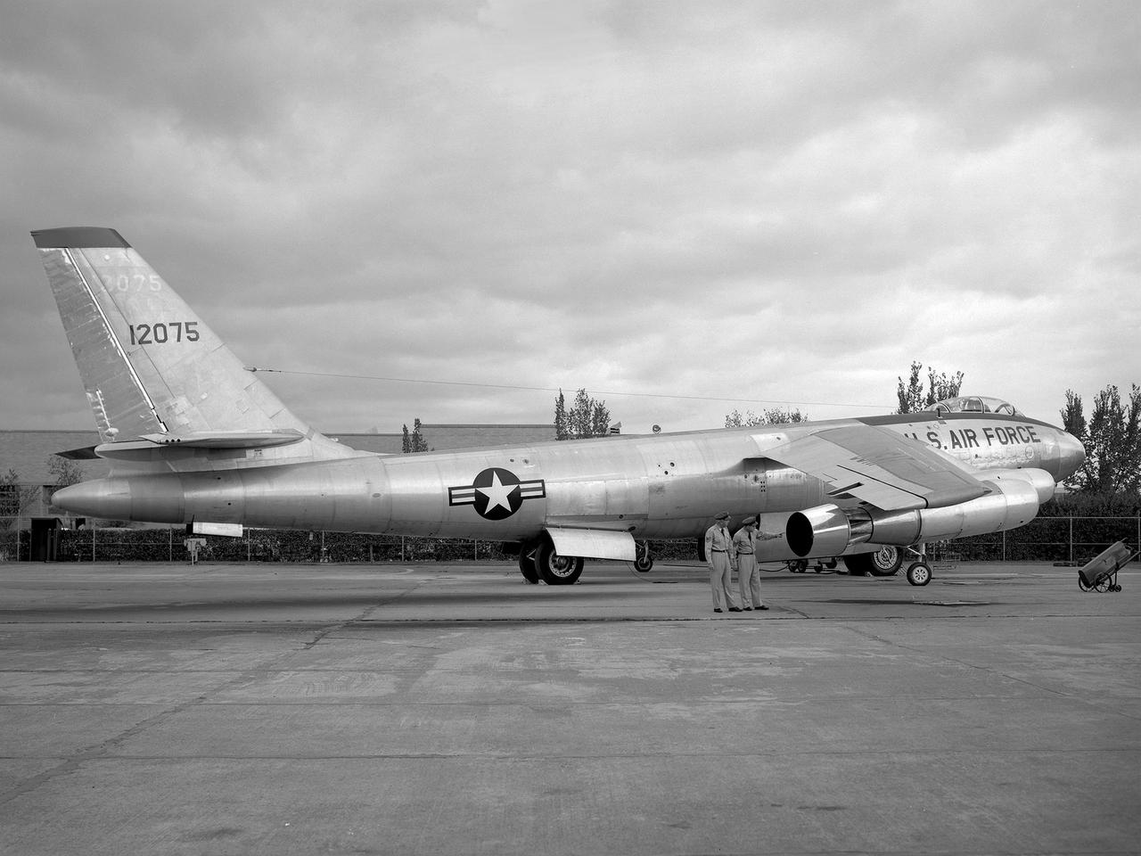 A Boeing B-47 Stratojet bomber with a noise-reducing ejector on its engine at the 1957 Inspection of the National Advisory Committee for Aeronautics (NACA) Lewis Flight Propulsion Laboratory. Representatives from the military, aeronautical industry, universities, and the press were invited to the laboratory to be briefed on the NACA’s latest research efforts and tour the state- of- the- art test facilities. Over 1700 people visited the NACA Lewis in Cleveland, Ohio during October 7 - 10, 1957.    By the mid-1950s, the aircraft industry was close to introducing jet airliners to the nation’s airways. The noise produced by the large jet engines, however, would pose a considerable problem for communities near airports. This problem was demonstrated at the 1957 Inspection by an NACA Lewis researcher who played longplay (LP) audio records of military jet engines for an audience. Tests showed that the source of the loudest noise was not the engine itself, but the mixing of the engine’s exhaust with the surrounding air in the atmosphere. The pressures resulting from this turbulence produced sound waves.     One of Lewis’ first studies sought to design an exhaust nozzle that reduced the turbulence. A Pratt and Whitney J57 was tested in the Altitude Wind Tunnel with many of these nozzle configurations from January to May 1957. Researchers found that the various nozzle types did reduce the noise levels but also reduced the aircraft’s thrust. Afterwards, they determined that the addition of an NACA-developed ejector reduced the noise levels without diminishing thrust.