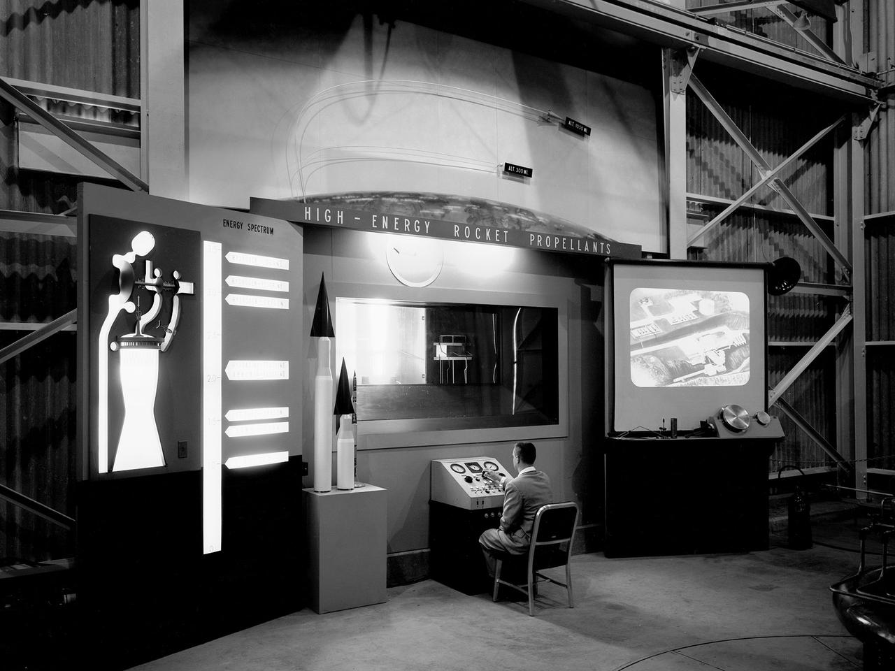 A researcher works a demonstration board in the Rocket Engine Test Facility during the 1957 Inspection of the National Advisory Committee for Aeronautics (NACA) Lewis Flight Propulsion Laboratory in Cleveland, Ohio. Representatives from the military, aeronautical industry, universities, and the press were invited to the laboratory to be briefed on the NACA’s latest research efforts and tour the test facilities. Over 1700 people visited the Lewis during the October 7-10, 1957 Inspection. The Soviet Union launched their first Sputnik satellite just days before on October 4.    NACA Lewis had been involved in small rockets and propellants research since 1945, but the NACA leadership was wary of involving itself too deeply with the work since ballistics traditionally fell under the military’s purview. The Lewis research was performed by the High Temperature Combustion section in the Fuels and Lubricants Division in a series of small cinderblock test cells. The rocket group was expanded in 1952 and made several test runs in late 1954 using liquid hydrogen as a propellant. A larger test facility, the Rocket Engine Test Facility, was approved and became operational just in time for the Inspection.