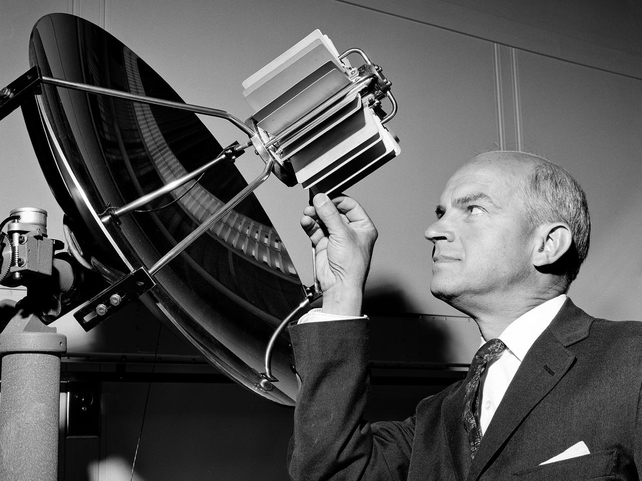 Walter Olson, Chief of the Chemistry and Energy Conversion Division, examines equipment in the new Energy Conversion Laboratory at the National Aeronautics and Space Administration (NASA) Lewis Research Center. The Energy Conversion Laboratory, built in 1961 and 1962, was a modest one-story brick structure with 30,000 square feet of working space. It was used to study fundamental elements pertaining to the conversion of energy into electrical power. The main application for this was space power, but in the 1970s it would also be applied for terrestrial applications. Olson joined the Lewis staff as a fuels and combustion researcher in 1942 and was among a handful or researchers who authored the new laboratory’s first technical report. The laboratory reorganized after the war and Olson was placed in charge of three sections of researchers in the Combustion Branch. They studied combustion and fuels for turbojets, ramjets, and small rockets. In 1950, Olson was named Chief of the entire Fuels and Combustion Research Division. In 1960 Olson was named Chief of the new Chemistry and Energy Conversion Division. It was in this role that Olson advocated for the construction of the Energy Conversion Laboratory. The new division expanded its focus from just fuels and combustion to new sources of energy and power such as solar cells, fuels cells, heat transfer, and thermionics.