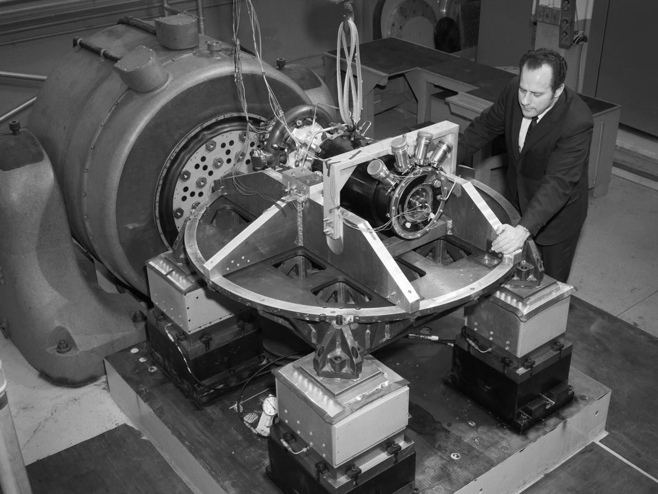 Aeronautics and Space Administration (NASA) Lewis Research Center. Aerojet General was contracted to design the SNAP-8 generator which employed a mercury Rankine system to convert the reactor’s heat into electrical power. The hermetically-sealed pump was designed to generate from 35 to 90 kilowatts of electrical power.     In 1964 a SNAP-8 test rig with a mercury boiler and condenser was set up in cell W-1 of Lewis’ Engine Research Building to study the transients in the system’s three loops. In 1967 a complete Rankine system was operated for 60 days in W-1 to verify the integrity of the Lewis-developed mercury boiler. Further tests in 1969 verified the shutdown and startup of the system under normal and emergency conditions. Aerojet operated the first full-Rankine system in June 1966 and completed a 2500-hour endurance test in early 1969. Lewis and Aerojet’s success on the Rankine system was acknowledged with NASA Group Achievement Award in November 1970.    The 1970 vibration tests, seen here, were conducted in Lewis’ Engine Research Building’s environmental laboratory. The testing replicated the shock and vibration expected to occur during the launch into space and subsequent maneuvering. The pump was analyzed on each of its major axes.