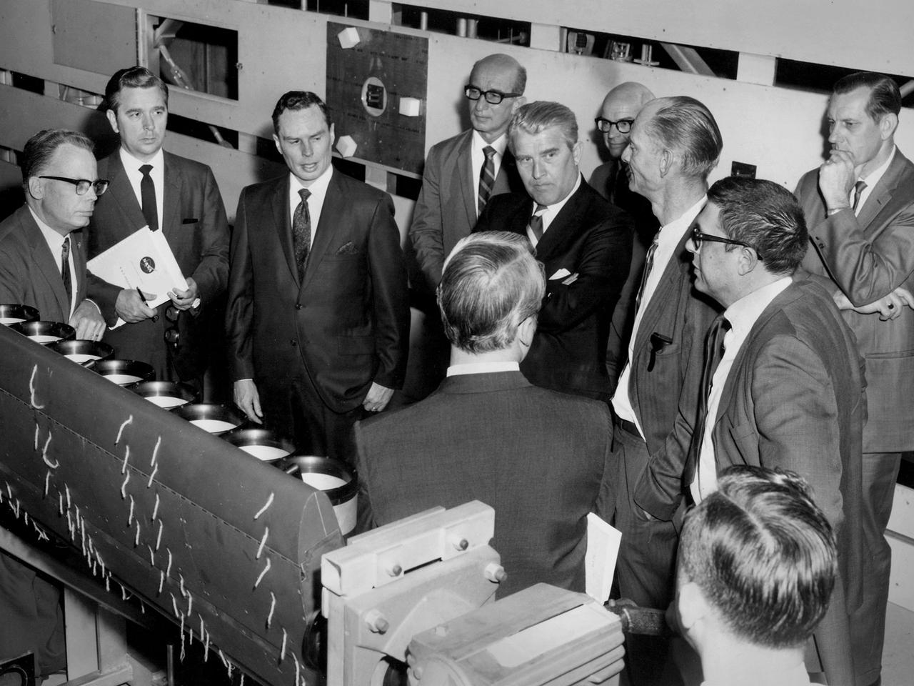 Werner von Braun, National Aeronautics and Space Administration (NASA) Deputy Associate Administrator for Planning, among a group from Headquarters touring the Lewis Research Center in Cleveland, Ohio. Lewis Special Projects Chief Newell Sanders, left, describes a Short Takeoff and Landing wing-propulsion model. Lewis had recently converted the return leg of its 8- by 6-Foot Supersonic Wind Tunnel into the 9- by 15-Foot Low Speed Wind Tunnel to investigate Vertical and Short Takeoff and Landing propulsion systems.    Gathered from the left near Sanders are James Daniels, Headquarters Executive Secretary; Oran Hicks, Acting Associate Administrator for the Headquarters Office of Advanced Research and Technology; Eugene Manganiello, Lewis Deputy Director; von Braun; Dr. Walter Olson, Lewis Assistant Director; Bruce Lundin, Lewis Director and Dr. Bernard Lubarsky, Lewis Assistant Director.     Just months before this photograph, NASA asked von Braun to give up his post as Director of the Marshall Space Flight Center after nearly ten years in order to head up the strategic planning effort for the agency from Washington DC. Von Braun retired from NASA two years later.