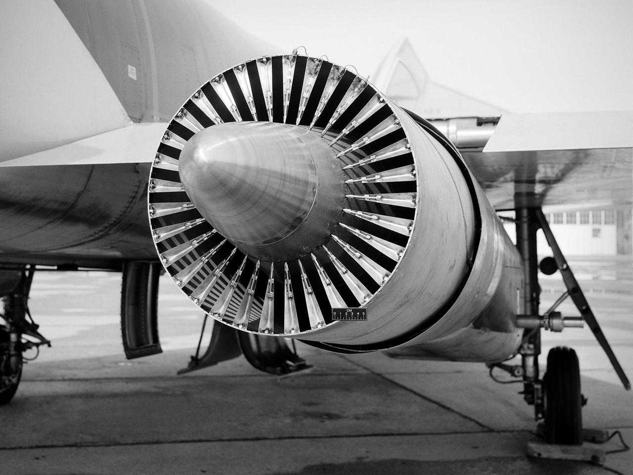 National Aeronautics and Space Administration (NASA) Convair F-106B Delta Dart with a 32-spoke nozzle installed on its General Electric J85 test engine. Lewis acquired a Delta Dart fighter in 1966 to study the components for propulsion systems that could be applied to supersonic transport aircraft at transonic speeds. The F-106B was modified with two General Electric J85-13 engines under its wings to study these components. The original test plan was expanded to include the study of boattail drag, noise reduction, and inlets.   From February to July 1971 the modified F-106B was used to study different ejector nozzles.  Researchers conducted both acoustic and aerodynamic tests on the ground and in flight. Several models were created to test different suppression methods. NASA Lewis’ conical nozzle was used as the baseline configuration.    Flightline and sideline microphones were set up on the ground. The F-106B would idle its own engine and buzz the recording station from an altitude of 300 feet at Mach 0.4 with the test engines firing.  Researchers found that the suppression of the perceived noise level was usually lower during flight than the researchers had statistically predicted. The 64 and 32-spoke nozzles performed well in actual flight, but the others nozzles tended to negatively affect the engine’s performance. Different speeds or angles- -of-attack sometimes changed the noise levels. In the end, no general conclusions could be applied to all the nozzles.