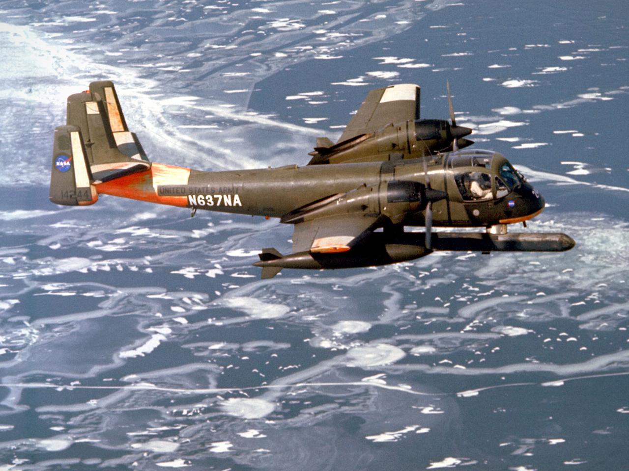 A Grumman OV-1B Mohawk maps Great Lakes’ ice flows for the National Aeronautics and Space Administration (NASA) Lewis Research Center in Cleveland, Ohio. The regular freezing of large portions of the Great Lakes during the winter frequently stalled the region’s shipping industry. Lewis developed two complementary systems to monitor the ice. The Side Looking Airborne Radar (SLAR) system used microwaves to measure the ice distribution, and electromagnetic systems employed noise modulation to determine the thickness of the ice. Once this dual system was in place, the information could be generated during a single pass of a research aircraft and quickly distributed to ship captains planning their routes. The SLAR was superior to aerial photography for this task because it was able to penetrate cloud cover. The SLAR system used pulsed microwaves to examine a band of ice or water on either side of the aircraft up to 31 miles wide. The Lewis ice mapping devices were first tested during the winter of 1972 and 1973. The system was installed on the tail of the Coast Guard’s OV-1B aircraft. An infrared thermal mapping instrument was installed on Lewis’ DC-3 to determine the ice temperature and estimate its thickness. The team created 160 ice charts that were sent to 28 ships and 2 icebreakers. Shipping was able to continue throughout the season for the first time that winter.