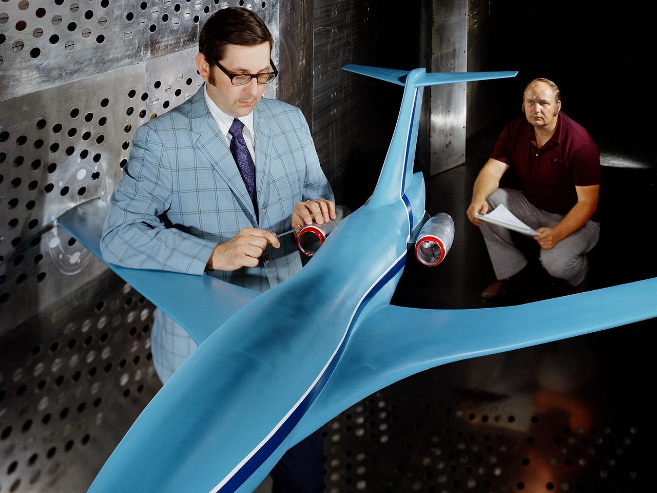 A researcher examines an Advanced Technology Transport model installed in the 8- by 6-Foot Supersonic Wind Tunnel at the National Aeronautics and Space Administration (NASA) Lewis Research Center. The Advanced Technology Transport concept was a 200-person supersonic transport aircraft that could cruise at Mach 0.9 to 0.98 with low noise and pollution outputs. General Electric and Pratt and Whitney responded to NASA Lewis’ call to design a propulsion system for the aircraft. The integration of the propulsion system with the airframe was one of the greatest challenges facing the designers of supersonic aircraft. The aircraft’s flow patterns and engine nacelles could significantly affect the performance of the engines. NASA Lewis researchers undertook a study of this 0.30-scale model of the Advanced Technology Transport in the 8- by 6-foot tunnel. The flow-through nacelles were located near the rear of the fuselage during the initial tests, seen here, and then moved under the wings for ensuing runs. Different engine cowl shapes were also analyzed. The researchers determined that nacelles mounted at the rear of the aircraft produced more efficient airflow patterns during cruising conditions at the desired velocities. The concept of the Advanced Technology Transport, nor any other US supersonic transport, has ever come to fruition. The energy crisis, environmental concerns, and inadequate turbofan technology of the 1970s were among the most significant reasons.