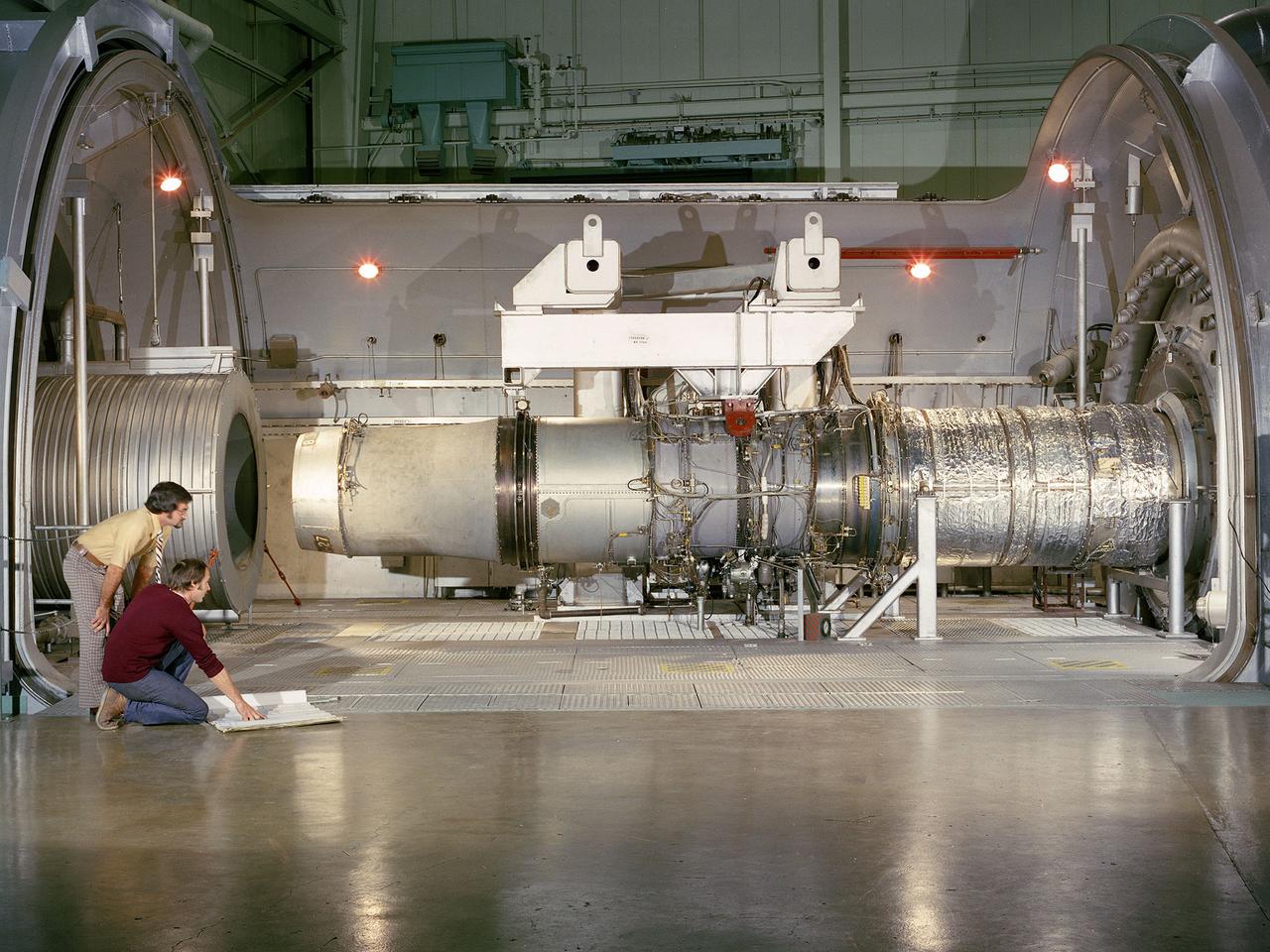A refanned Pratt and Whitney JT-8D-109 turbofan engine installed in Cell 4 of the Propulsion Systems Laboratory at the National Aeronautics and Space Administration (NASA) Lewis Research Center. NASA Lewis’ Refan Program sought to demonstrate that noise reduction modifications could be applied to existing aircraft engines with minimal costs and without diminishing the engine’s performance or integrity. At the time, Pratt and Whitney’s JT-8D turbofans were one of the most widely used engines in the commercial airline industry. The engines powered Boeing’s 727 and 737 and McDonnell Douglas’ DC-9 aircraft.    Pratt and Whitney worked with the airline manufacturers on a preliminary study that verified feasibility of replacing the JT-8D’s two-stage fan with a larger single-stage fan. The new fan slowed the engine’s exhaust, which significantly reduced the amount of noise it generated. Booster stages were added to maintain the proper level of airflow through the engine. Pratt and Whitney produced six of the modified engines, designated JT-8D-109, and performed the initial testing.     One of the JT-8D-109 engines, seen here, was tested in simulated altitude conditions in NASA Lewis’ Propulsion Systems Laboratory. The Refan engine was ground-tested on an actual aircraft before making a series of flight tests on 727 and DC-9 aircraft in early 1976. The Refan Program reduced the JT-8D’s noise by 50 percent while increasing the fuel efficiency. The retro-fit kits were estimated to cost between $1 million and $1.7 million per aircraft.
