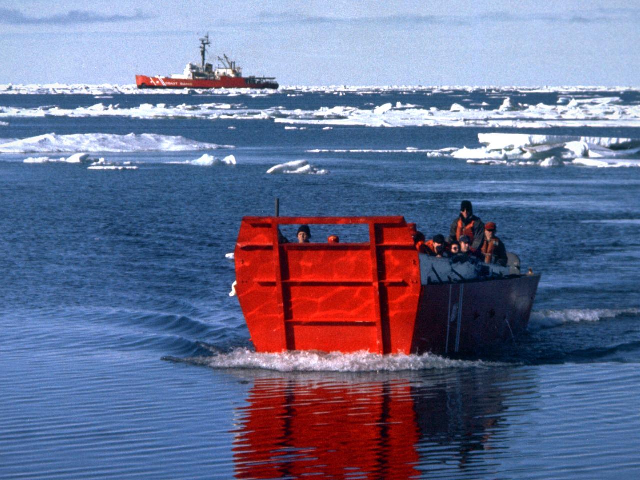 A group of Coast Guard seamen leave their ship to verify ice formations on the Great Lakes as part of an joint effort with the National Aeronautics and Space Administration (NASA) Lewis Research Center and the National Oceanic and Atmospheric Administration. The regular winter freezing of large portions of the Great Lakes stalled the shipping industry. Lewis began working on two complementary systems to monitor the ice. The Side Looking Airborne Radar (SLAR) system used microwaves to measure the ice distribution and electromagnetic systems used noise modulation to determine the thickness of the ice. The images were then transferred via satellite to the Coast Guard station. The Coast Guard then transmitted the pertinent images by VHF to the ship captains to help them select the best route.    The Great Lakes ice mapping devices were first tested on NASA aircraft during the winter of 1972 and 1973. The pulsed radar system was transferred to the Coast Guard’s C-130 aircraft for the 1975 and 1976 winter. The SLAR was installed in the rear cargo door, and the small S-band antenna was mounted to the underside of the aircraft. Coast Guard flights began in January 1975 at an altitude of 11,000 feet. Early in the program, teams of guardsmen and NASA researchers frequently set out in boats to take samples and measurements of the ice in order to verify the radar information.