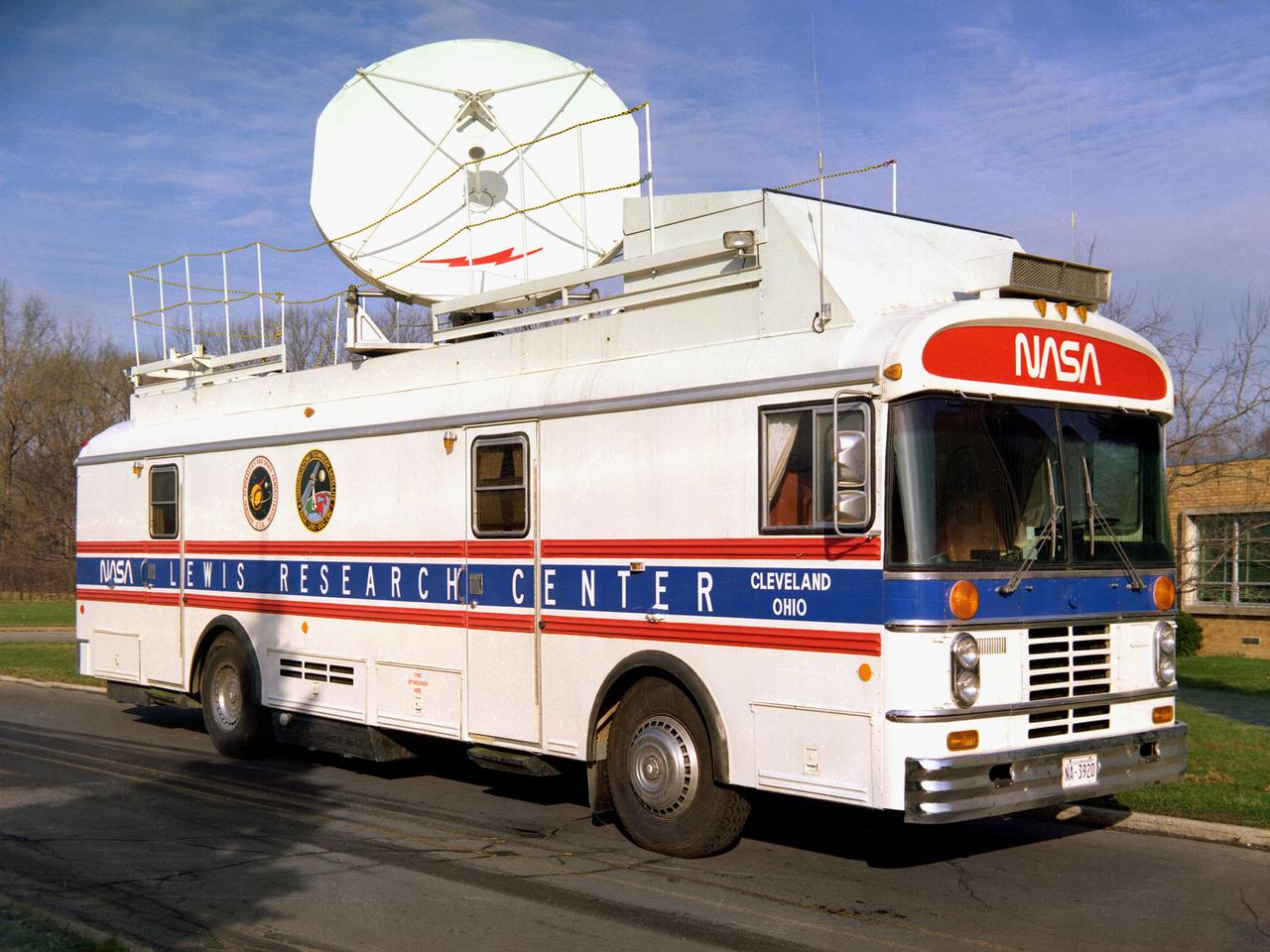This vehicle served as a mobile terminal for the Communications Technology Satellite. The Communications Technology Satellite was an experimental communications satellite launched in January 1976 by the National Aeronautics and Space Administration (NASA) and the Canadian Department of Communications. The satellite operated in a new frequency band reserved for broadcast satellites with transmitting power levels that were 10 to 20 times higher than those of contemporary satellites. Throughout 1977 and 1978 NASA allowed qualified groups to utilize the satellite from one of the three ground-based transmission centers. NASA’s Lewis Research Center in Cleveland, Ohio was NASA’s lead center on the project. Lewis was responsible for the control and coordination of all US experiments on the satellite. The center housed the satellite’s main control center which included eight parabolic reflector antennae ranging from 2 to 15 feet in diameter. Many of the satellite’s components had been tested in simulated space conditions at Lewis. The Lewis-designed vehicle seen here served as a field unit for transmitting and receiving wideband signals and narrowband voice. The vehicle permitted live television interviews, recording equipment, and cameras. An 8-foot diameter parabolic reflector was mounted on the roof. The interior of the vehicle had workstations, monitors, transmitting equipment, and a lounge area.