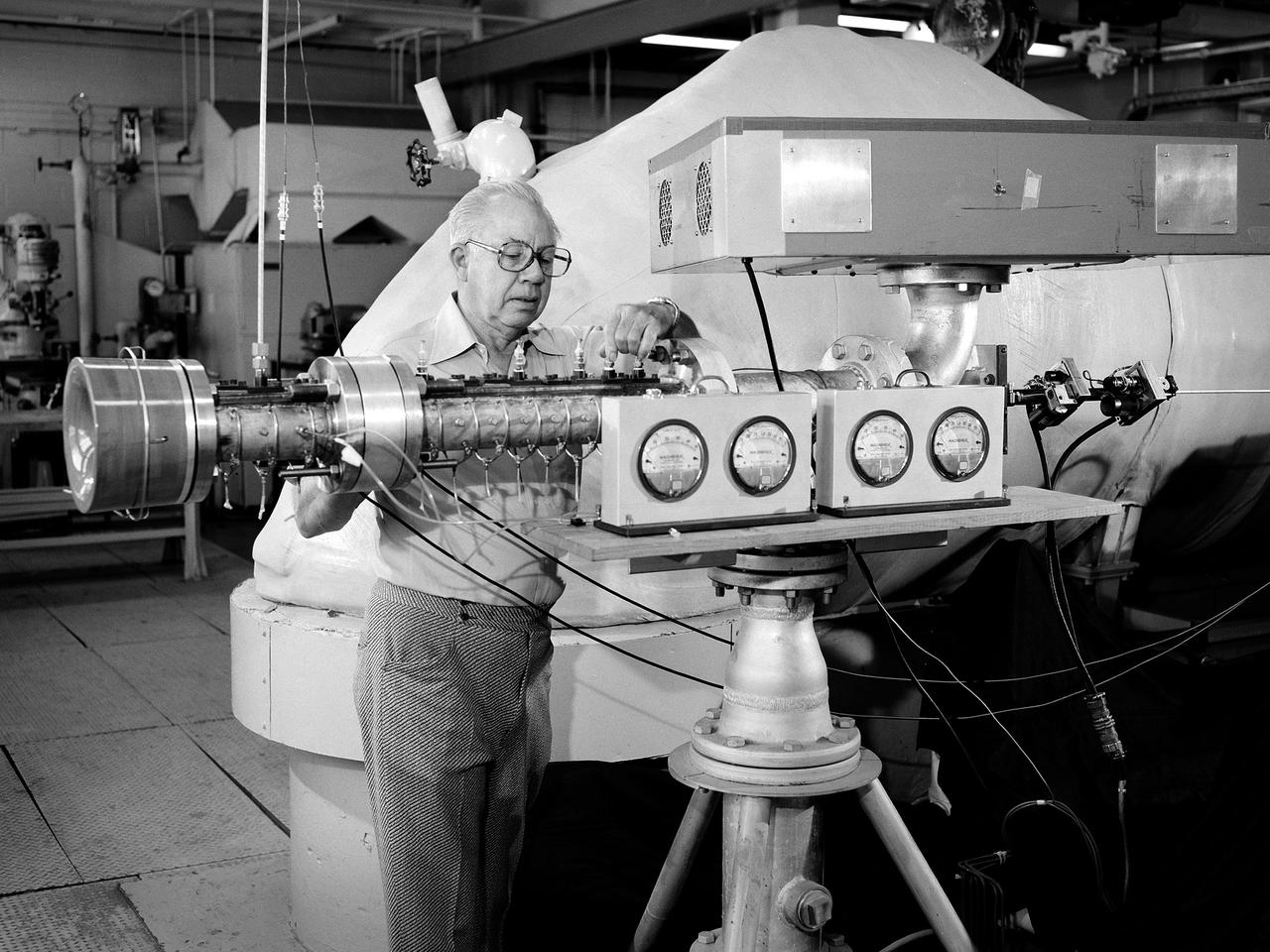 An engineer examines the Coherent Turbulence Rig in the Engine Research Building at the National Aeronautics and Space Administration (NASA) Lewis Research Center. Coherent turbulence occurs when waves of uniform size and alignment are present in airflow. Researchers at NASA Lewis were interested in determining the relation between the size of the waves and their heat transfer properties. The massive 4.25-acre Engine Research Building contains dozens of test cells, test stands, and altitude chambers. A powerful a collection of compressors and exhausters located in the central portion of the basement provides process air and exhaust for these test areas. This system is connected to similar process air systems in the laboratory’s other large test facilities. The Central Control Room coordinates this activity and communicates with the local utilities.