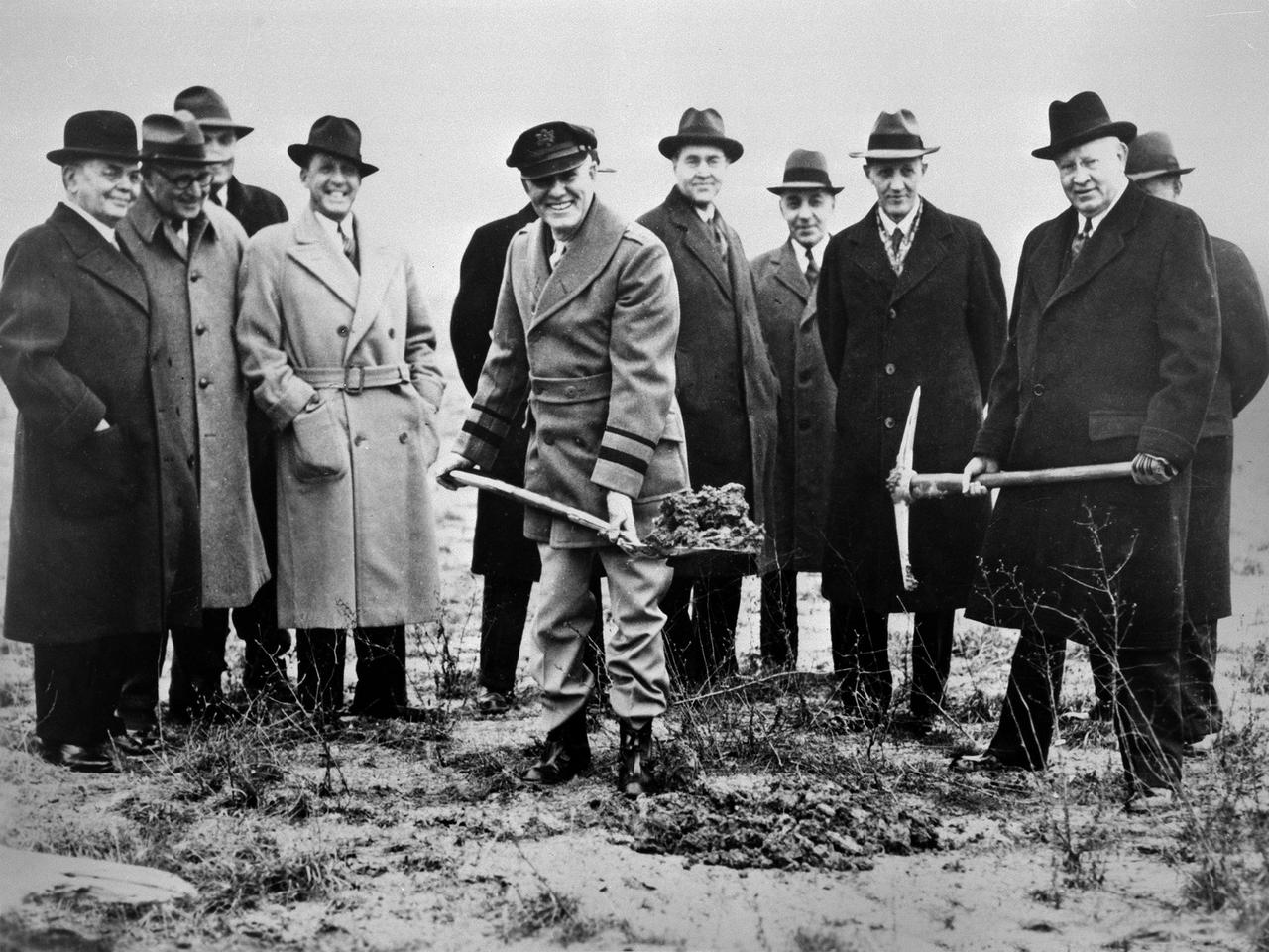 Local politicians and National Advisory Committee for Aeronautics (NACA) officials were on hand for the January 23, 1941 groundbreaking for the NACA’s Aircraft Engine Research Laboratory (AERL).  The NACA was established in 1915 to coordinate the nation’s aeronautical research. The committee opened a research laboratory at Langley Field in 1920. By the late 1930s, however, European nations, Germany in particular, were building faster and higher flying aircraft. The NACA decided to expand with a new Ames Aeronautical Laboratory dedicated to high-speed flight and the AERL to handle engine-related research.  The NACA examined a number of Midwest locations for its new engine lab before deciding on Cleveland. At the time, Cleveland possessed the nation’s most advanced airport, several key aircraft manufacturing companies, and was home to the National Air Races. Local officials were also able to broker a deal with the power company to discount its electricity rates if the large wind tunnels were operated overnight. The decision was made in October 1940, and the groundbreaking alongside the airport took place on January 23, 1941.   From left to right:  William Hopkins, John Berry, Ray Sharp, Frederick Crawford, George Brett, Edward Warner, Sydney Kraus, Edward Blythin, and George Lewis