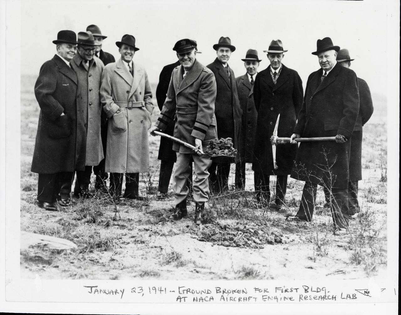January 23, 1941 groundbreaking ceremony at the NACA Aircraft Engine Research Laboratory: left to right (does not include two individuals obscured from view behind Maj. Brett and Dr. Lewis):   • William R. Hopkins – Cleveland City Manager from 1924-1930, was personally responsible for planning and acquiring the land for the Cleveland Airport. The airport’s huge capacity for handling aircraft was one factor in selecting Cleveland for the site of the research center.  The Cleveland Airport was renamed Cleveland Hopkins airport in his honor in 1951.  • Major John Berry – Cleveland Airport Manager  • Edward R. Sharp – GRC’s first director, serving from 1942 to his retirement in 1961.  He came to Cleveland in 1941 as the construction manager for the new facility.  • Frederick C. Crawford – President of Thompson Products, which became the Thompson-Ramo-Woolridge Corporation (TRW) in 1958.  Crawford was, at the time, also president of the Cleveland Chamber of Commerce.  He began in 1939 to campaign for Cleveland as the location for the new NACA facility.  • Major George H. Brett – A Cleveland native, Brett served in WWI and was commanding officer at Wright Field in Dayton, Ohio before becoming chief of the Army Air Corps.  • Dr. Edward P. Warner – Acting chairman of the NACA.  • Captain Sydney M. Kraus – Officer in charge of Navy procurement  • Edward Blythin – Mayor of Cleveland  • Dr. George Lewis – Director of Aeronautical Research for the NACA from 1924-1947, Lewis devoted his life to building a scientific basis for aeronautical engineering.  The Cleveland laboratory was renamed the Lewis Flight Propulsion Laboratory in his honor in 1948.   A description of the event, based on newspaper accounts and later NASA publications is as follows:  On January 23, 1941, a brief groundbreaking ceremony at the site marked the start of construction. Dr. George W. Lewis, director of research for the NACA, loosened the soil with a 