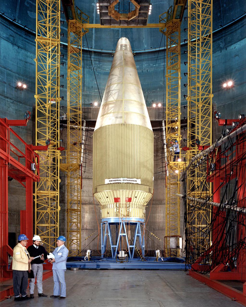 Employees at the Space Power Facility (SPF) at Plum Brook Station tested a new generation of Atlas/Centaur launch vehicles.  General Dynamics conducted the tests December 22 and January 3, 1990 to determine the flight readiness of a new 14-foot diameter payload fairing.  The fairing will accommodate new weather satellites, the U.S. Air Force Combined Release and Radiation Effects (CRRES) satellite, and other future payloads.  At a simulated altitude of 85,000 feet, the cone-shaped fairing separated in half from a hinge at the bottom.  Half of the fairing was then released from the test stack and recovered in a catch-net.  The payload fairing separations were the first tests of major space hardware to be conducted in the SPF in more than 15 years.