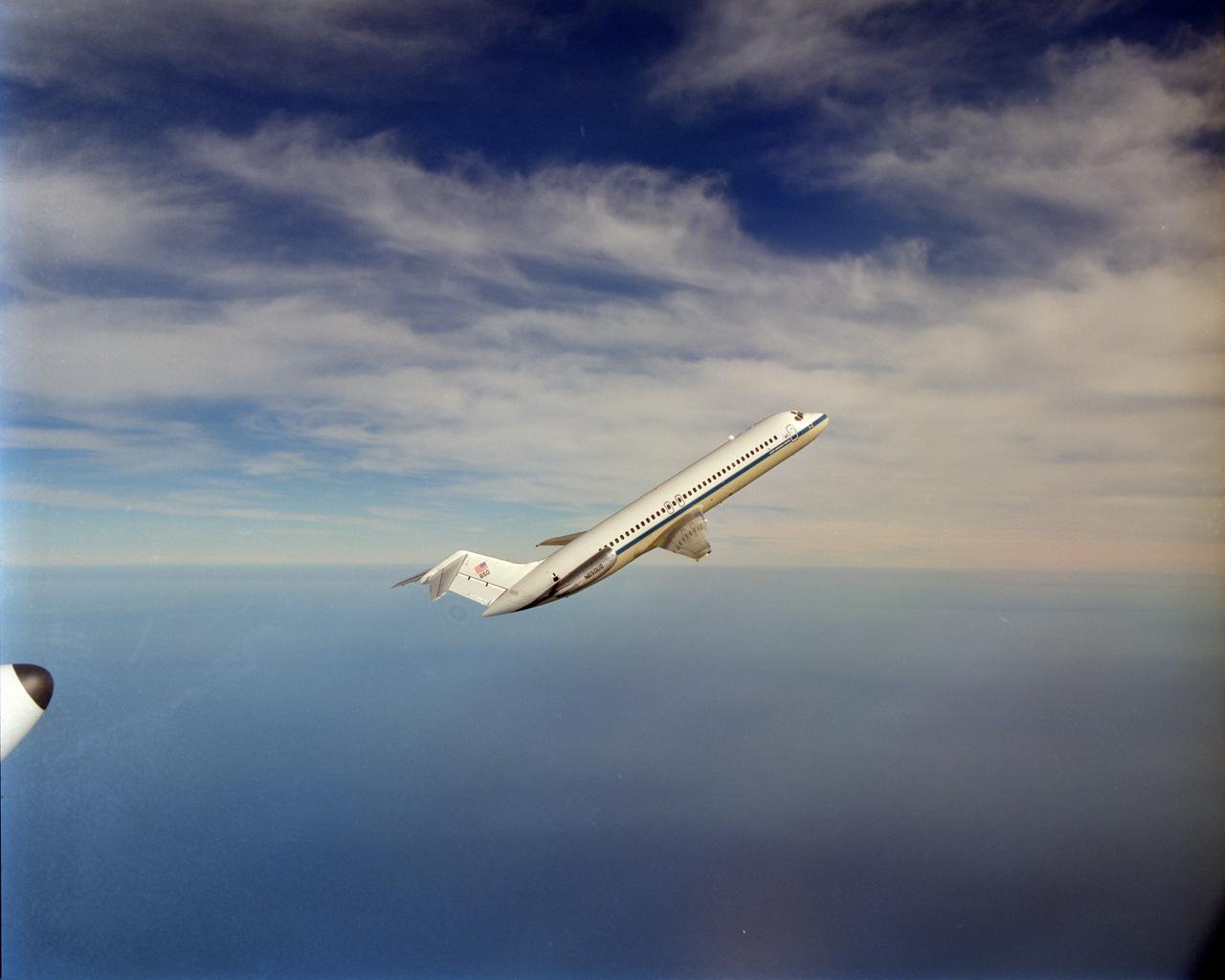 NASA aircraft DC-9 microgravity plane performs it's first test parabolas over Lake Erie. This was photographed by the NASA Glenn Lear Jet in a chase plane configuration.