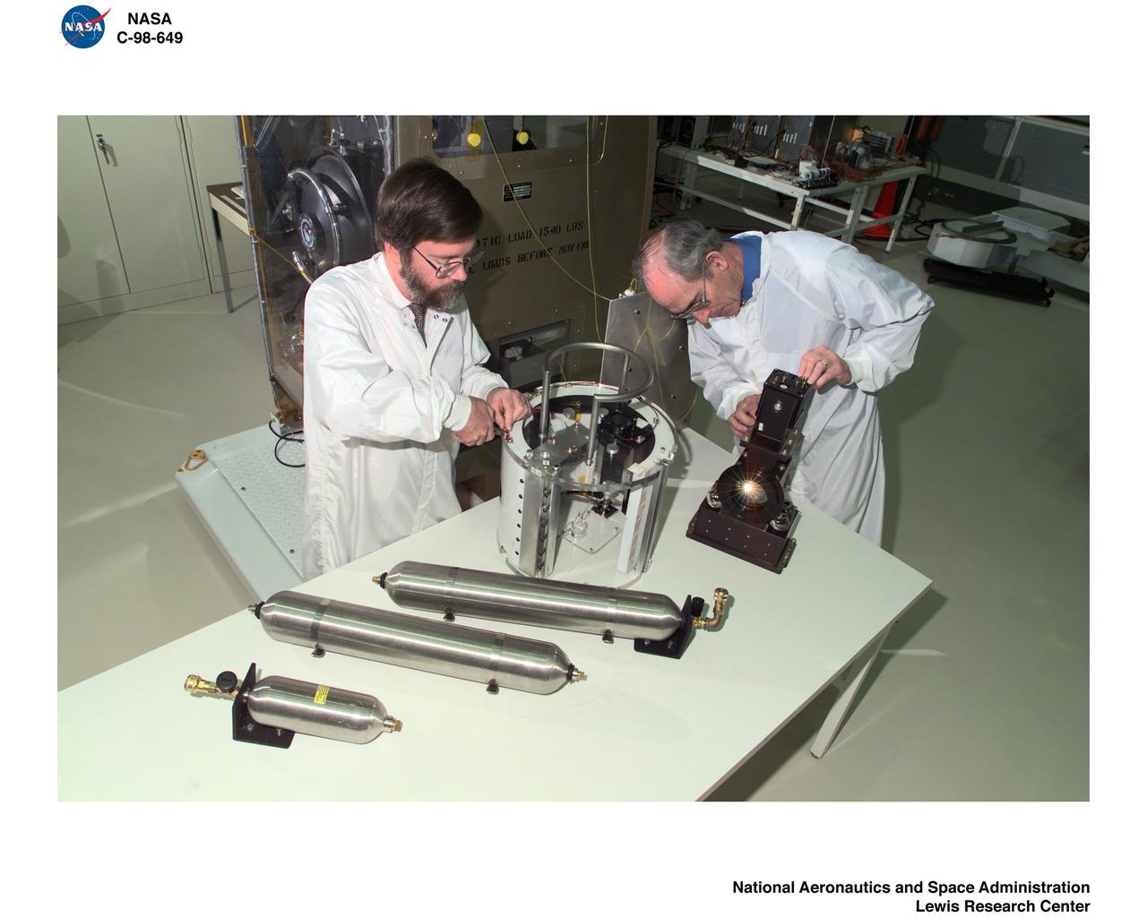 LEWIS RESEARCHERS WORKING ON FLUIDS AND COMBUSTION FACILITY COMPONENTS