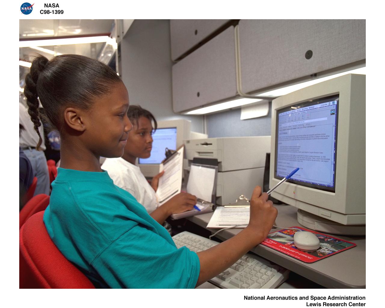STUDENTS WORKING AT THE MAEL TRAILER MOBILE AERONAUTICS EDUCATIONAL LABORATORY