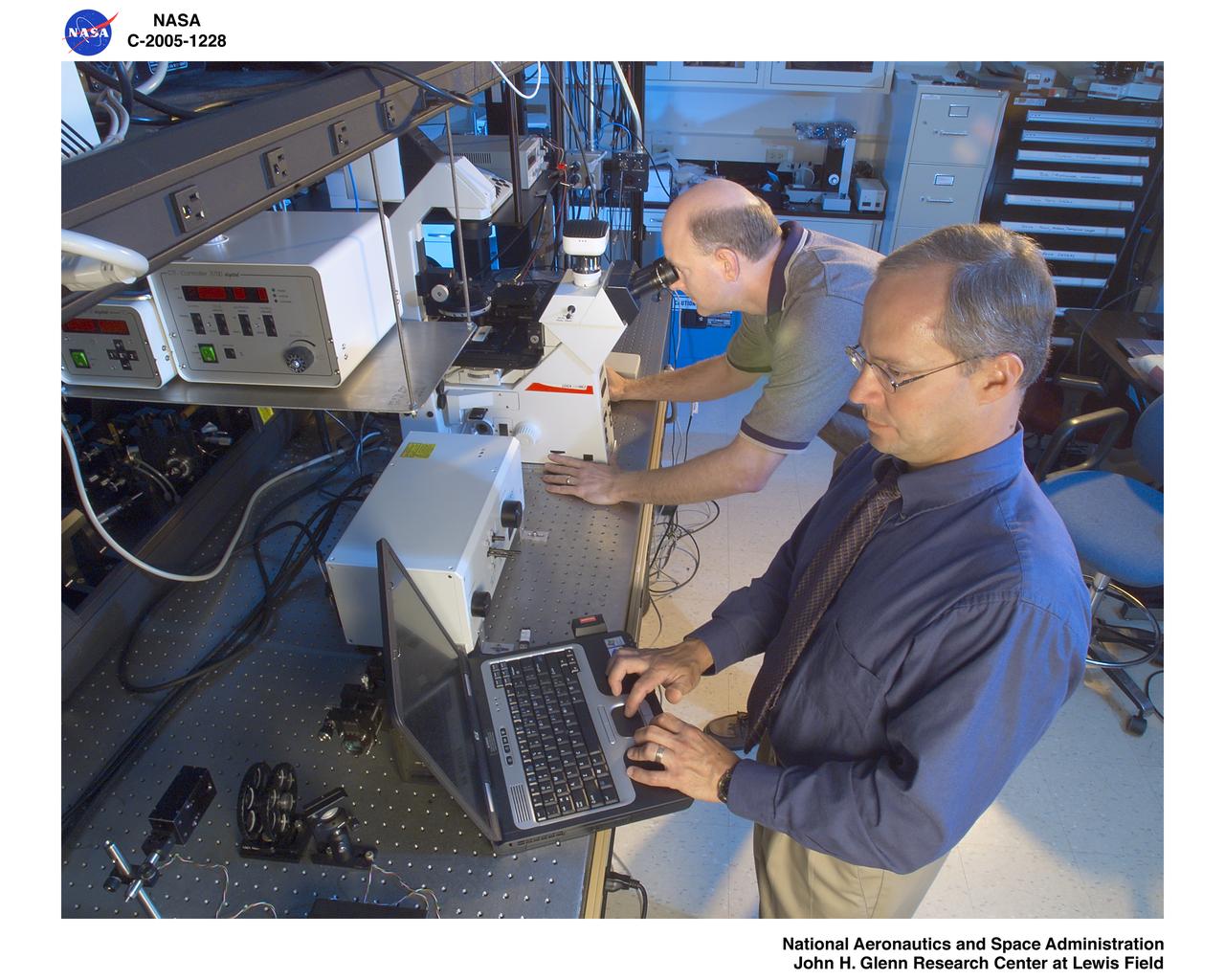 Researchers using microscope in Biophotonics Lab