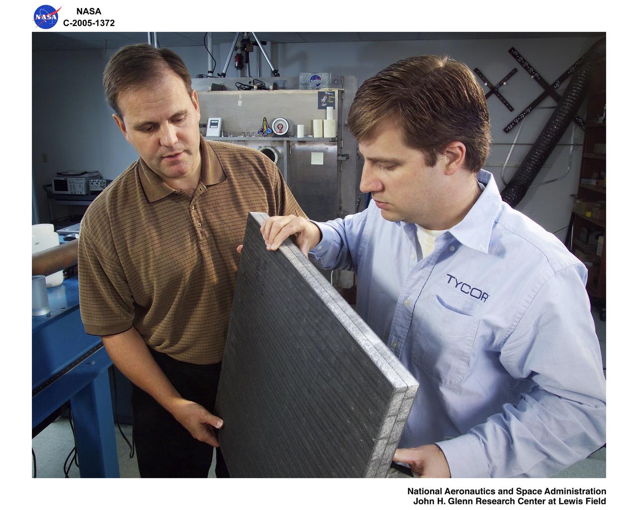 WebCore Technologies, Fiber-reinforced Foam Core Composite Sandwich Panel during preparation for testing in the Ballistic Impact Lab. Pictured: Dale Hopkins, GRC and Mike Sheppard, Web Core Technologies Cross reference to camera file number: G6QJ0101