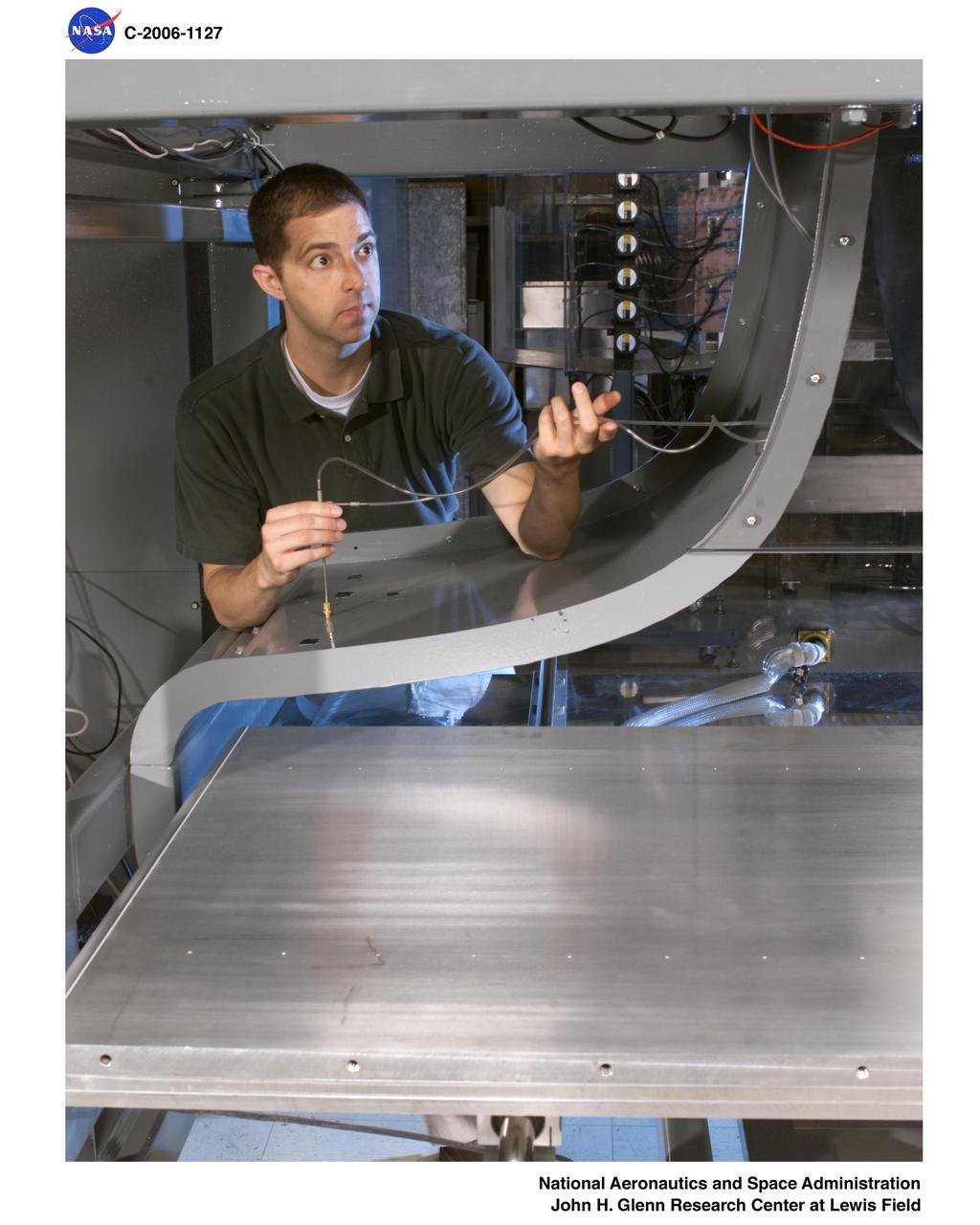 Icing Physics Flow Lab at Case Western Reserve University. Test bed in rolled out position with researcher making adjustments