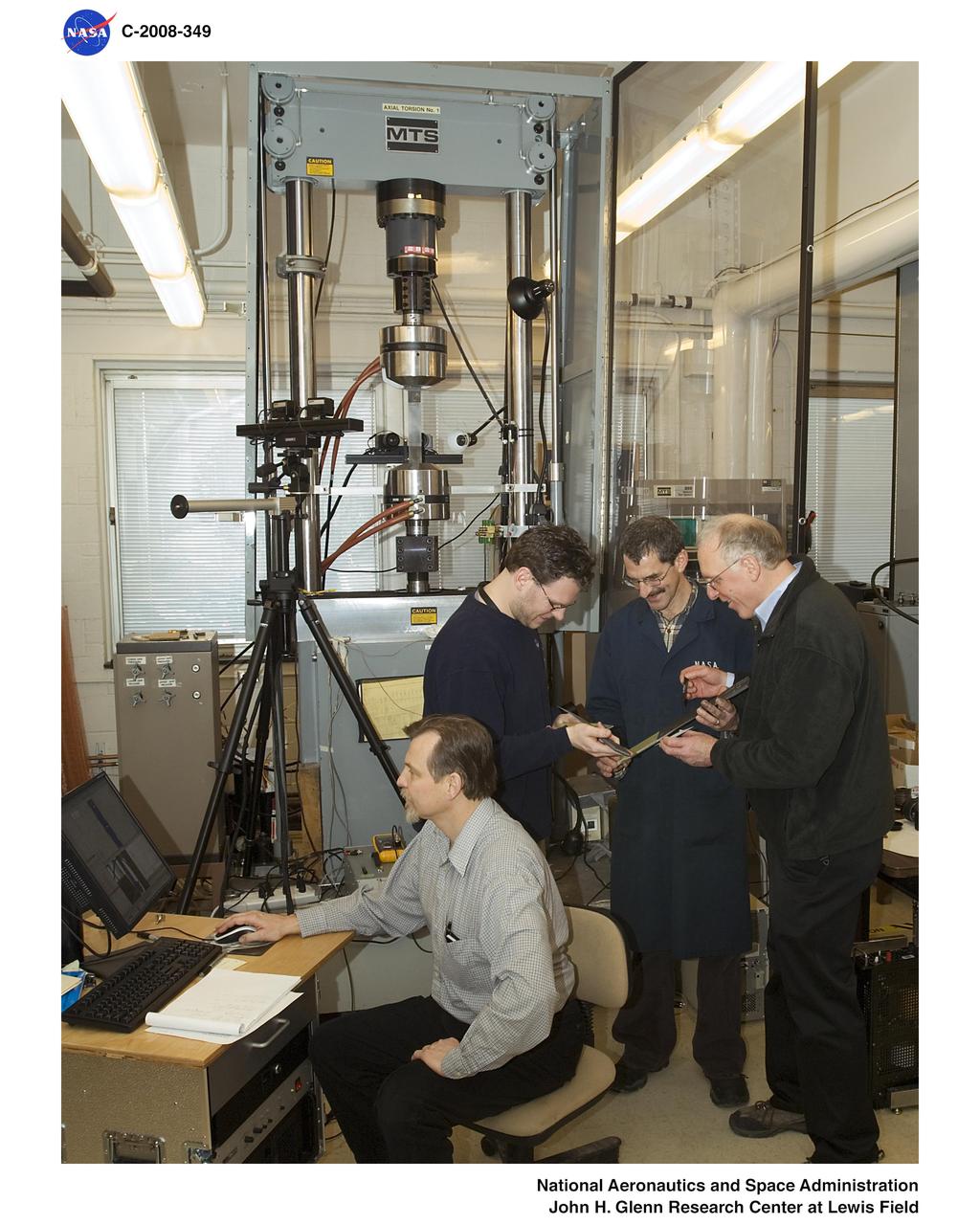 Code R and Code D hosted NESC Principal Engineer Mike Kirsch who is Program Leader for Composite Crew Module (CCM).  The purpose of the visit was to review/observe experiments that GRC is performing in support of the CCM program.  The test object is the critical Low Impact Docking System/Tunnel interface joint that links the metal docking ring with the polymer composite tunnel element of the crew module pressure vessel.  The rectangular specimens simulated the splice joint between the aluminum and the PMC sheets, including a PMC doubler sheet.  GRC was selected for these tests due to our expertise in composite testing and our ability to perform 3D fullfield displacement and strain measurements of the complex bond geometry using digital image correlation.  The specimens performed above their minimum load requirements and the full field strain measurements showed the strain levels at the critical bond line.  This work is part of a joint Code D & R investigation.