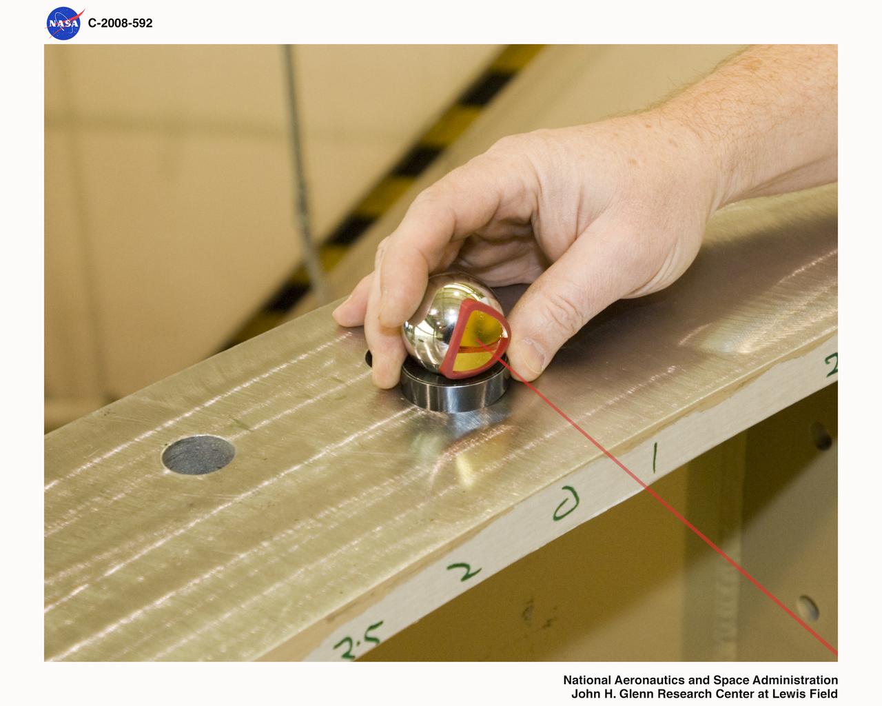 Laser level system in use on an Ares 1-X segment checking for level on the flange