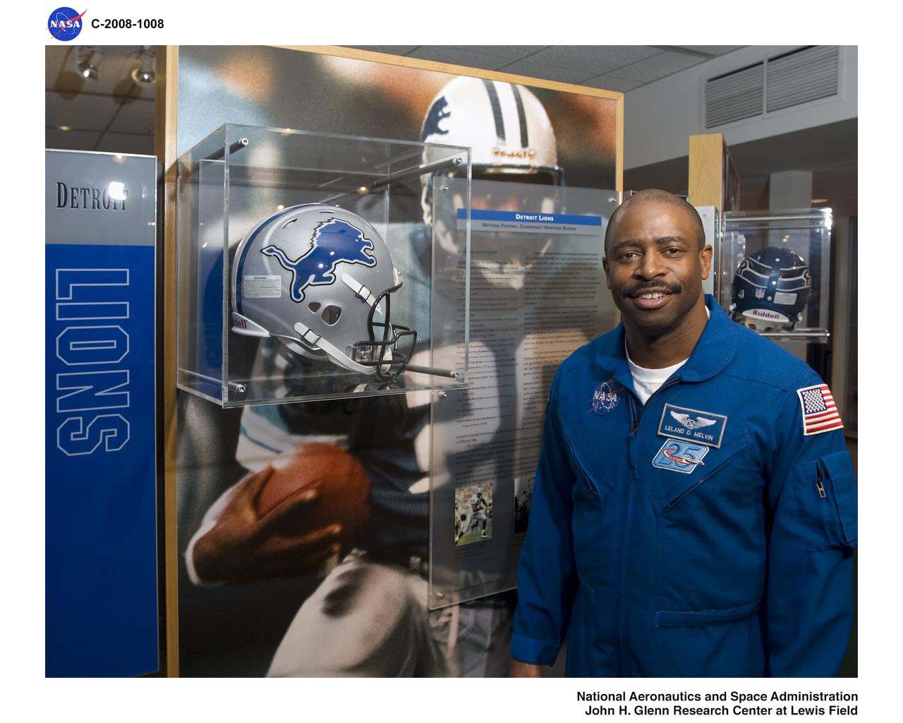 STS-122 Crew Members visit the Pro Football Hall of Fame in Canton Ohio. STS-122 Astronaut poses by a Detroit Lions display case. He was drafted by the Lions in 1986