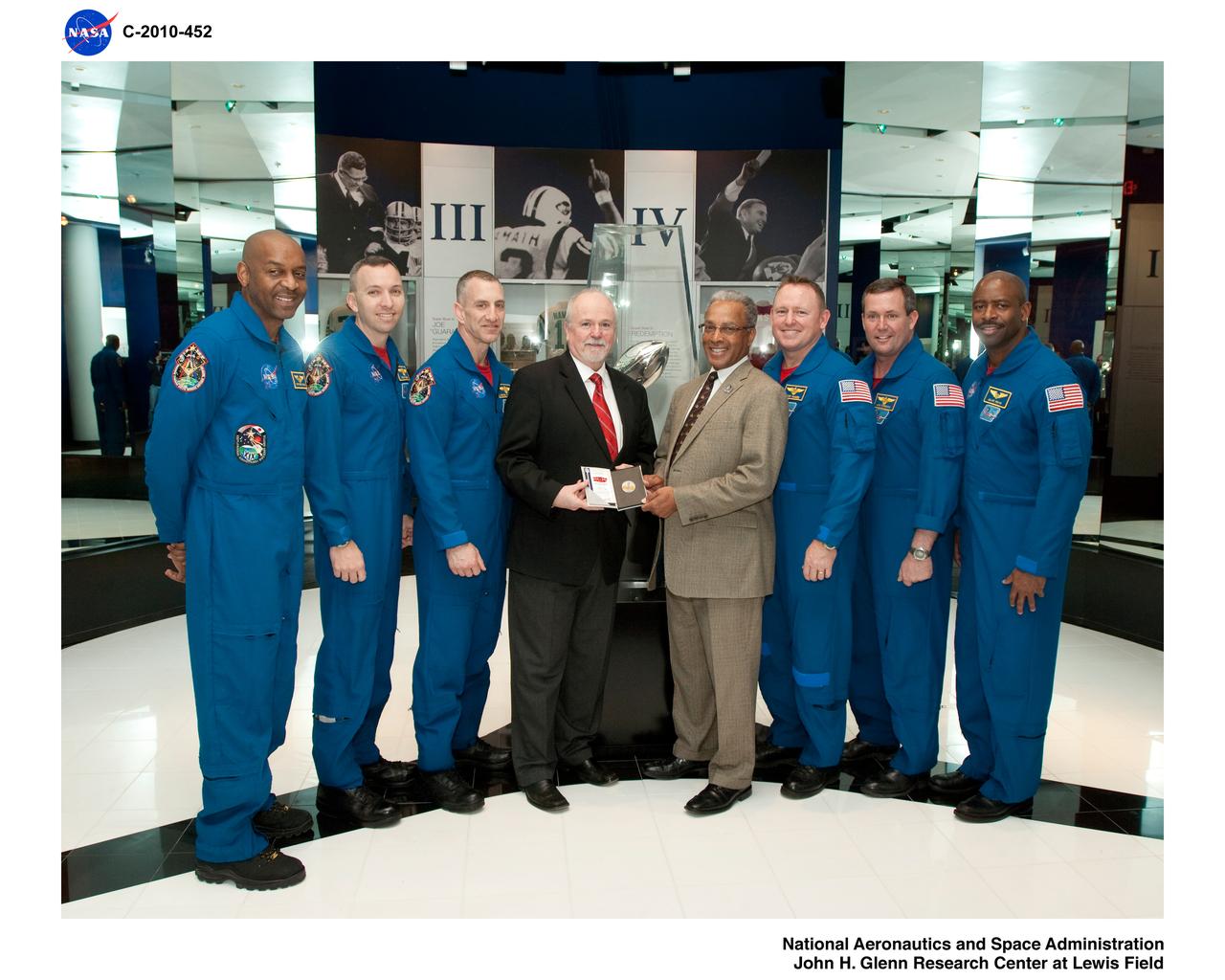 From Space to the Super Bowl Members of the STS-129 shuttle mission present a specially minted silver medallion to National Football League officials on Wednesday, Jan. 27, 2010, at the Pro Football Hall of Fame in Canton, Ohio. The coin, which was flown in space during the November flight of Atlantis, will be used for the official coin toss prior to the kickoff of Super Bowl XLIV on Sunday, Feb. 7, 2010. One member of Atlantis' crew, Leland Melvin, was drafted by the NFL's Detroit Lions in 1986. The crew also flew other NFL-related memorabilia, including jerseys and a football inscribed with the name of every member of the Hall of Fame. From left: Astronauts Bobby Satcher, Randy Bresnik, and Charlie Hobaugh; Joe Horrigan, Vice President of Communications/Exhibits for the Pro Football Hall of Fame, Steve Perry, President/Executive Director of the Pro Football Hall of Fame; astronauts Berry Wilmore, Michael Foreman and Leland Melvin. Photo Credit: NASA/Marv Smith