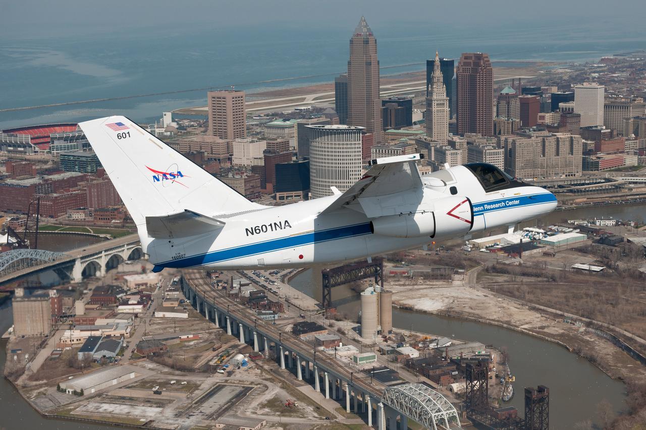 This photo shows NASA Glenn’s S-3 Viking Aircraft flying over downtown Cleveland, Ohio. The S-3 continues to conduct important research including regular flights over Lake Erie and other waterways to image algal blooms that have plagued the area’s waters.