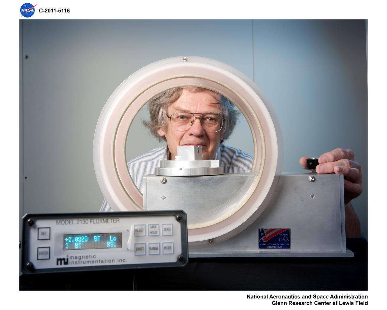 Janis Niedra (RPT/Thermal Energy Conversion Branch) is using a Helmholtz coil to measure the approximate remanence of a magnet segment. The magnet segment being measured is similar to the ones used in the linear alternator of the Advanced Stirling Convertor (ASC) which was designed and built by Sunpower, Inc. The magnet (not shown in this view) is positioned in the slot cut along the top of the aluminum block which is positioned at the center of the coil in the region of uniform sensitivity. The ASC is the type of free-piston Stirling convertor that is used in the Advanced Stirling Radioisotope Generator (ASRG) currently being developed by Lockheed-Martin for the Department of Energy and NASA.