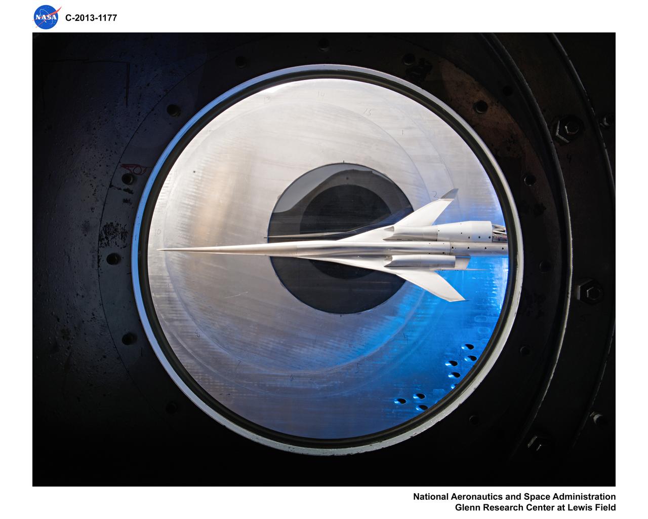 Supersonic Aircraft Model The window in the sidewall of the 8- by 6-foot supersonic wind tunnel at NASA's Glenn Research Center shows a 1.79 percent scale model of a future concept supersonic aircraft built by The Boeing Company. In recent tests, researchers evaluated the performance of air inlets mounted on top of the model to see how changing the amount of airflow at supersonic speeds through the inlet affected performance. The inlet on the pilot's right side (top inlet in this side view) is larger because it contains a remote-controlled device through which the flow of air could be changed. The work is part of ongoing research in NASA's Aeronautics Research Mission Directorate to address the challenges of making future supersonic flight over land possible. Researchers are testing overall vehicle design and performance options to reduce emissions and noise, and identifying whether the volume of sonic booms can be reduced to a level that leads to a reversal of the current ruling that prohibits commercial supersonic flight over land. Image Credit: NASA/Quentin Schwinn