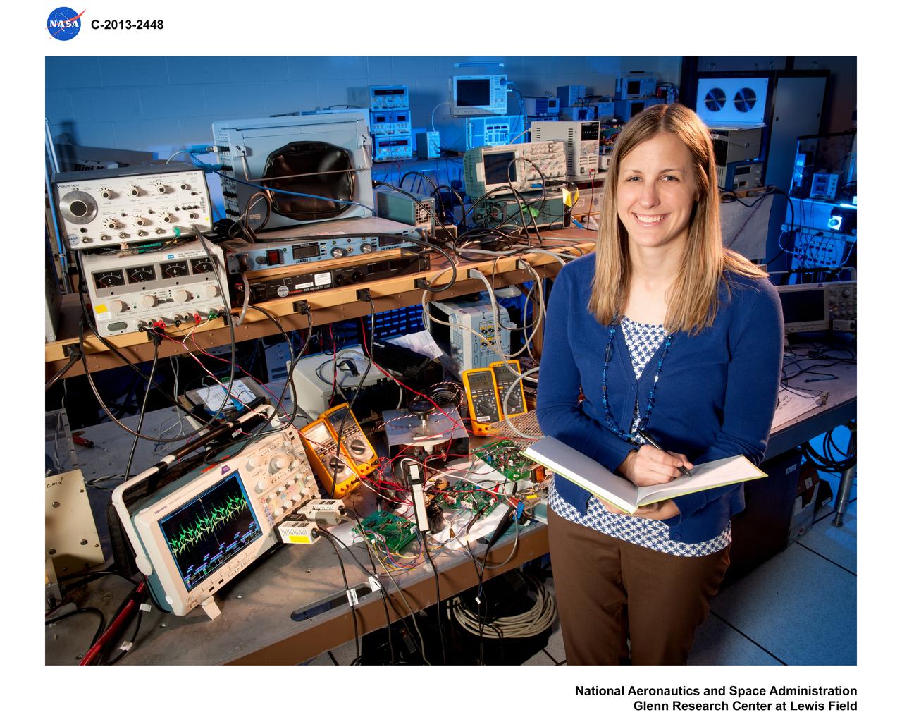 Environmental Portrait, Electrical Power Systems Employee, hardware for the High Power 300-Volt Power Processing Unit (PPU). The Printed Circuit Boards (PCBs) are the Discharge Module Inverter and the Pulse Width Modulation (PWM) Controller