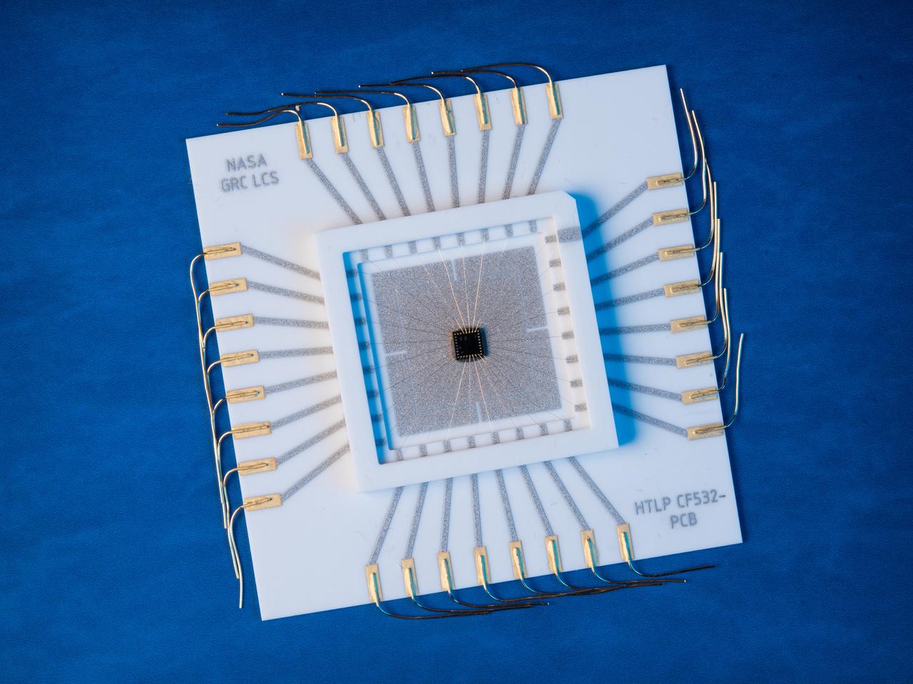 A multilevel interconnect silicon carbide integrated circuit chip with co-fired ceramic package and circuit board recently developed at the NASA GRC Smart Sensors and Electronics Systems Branch for high temperature applications. High temperature silicon carbide electronics and compatible packaging technologies are elements of instrumentation for aerospace engine control and long term inner-solar planet explorations.
