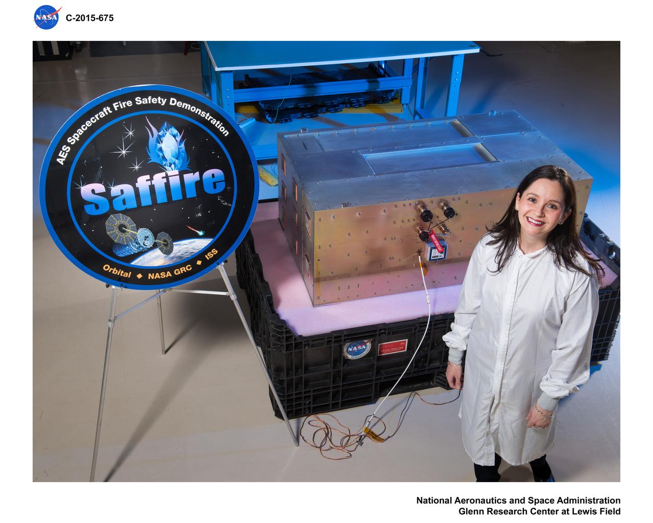 NASA Advanced Exploration Systems, Spacecraft Fire Safety Demonstration, Chief Scientist poses with the flight hardware.  Photo taken for a NASA GRC Web Feature
