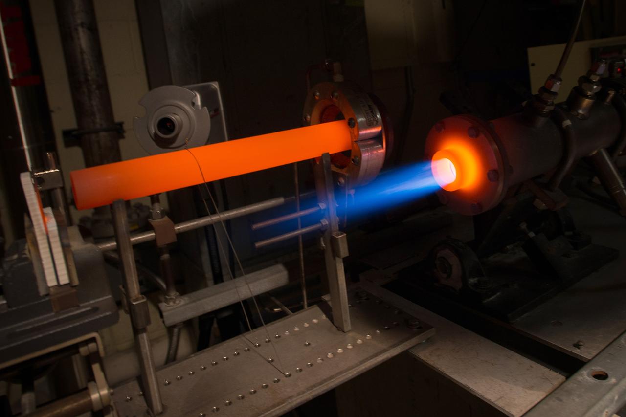 The Fuel Burner Rig is a test laboratory at NASA Glenn, which subjects new jet engine materials, treated with protective coatings, to the hostile, high temperature, high velocity environment found inside aircraft turbine engines. These samples face 200-mile per hour flames to simulate the temperatures of aircraft engines in flight. The rig can also simulate aircraft carrier and dusty desert operations where salt and sand can greatly reduce engine life and performance.