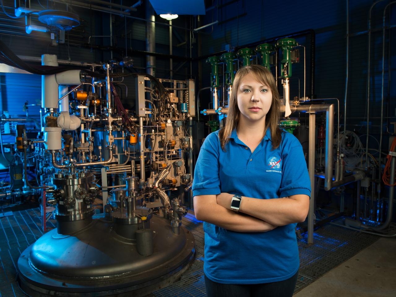 NASA Glenn engineer Monica Guzik in the Small Multi-Purpose Research Facility (SMiRF). The facility provides the ability to simulate the environmental conditions encountered in space for a variety of cryogenic applications such as thermal protection systems, fluid transfer operations and propellant level gauging. SMiRF is a low-cost, small-scale screening facility for concept and component testing of a wide variety of hardware and is capable of testing cryogenic hydrogen, oxygen, methane and nitrogen.