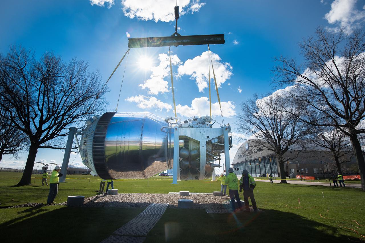 The 6,600 pound Centaur test article is a rare artifact recently transported from the U.S. Space and Rocket Center in Alabama.  Centaur, developed at NASA Glenn Research Center in the late 1950s, was the world's first high-energy upper stage, burning liquid hydrogen (LH2) and liquid oxygen (LOX), and has enabled the launch of some of NASA's most important scientific missions over its 50-year history. In this image, technicians prepare to mount the hardware on a permanent display stand close to the main entrance at NASA Glenn Research Center.