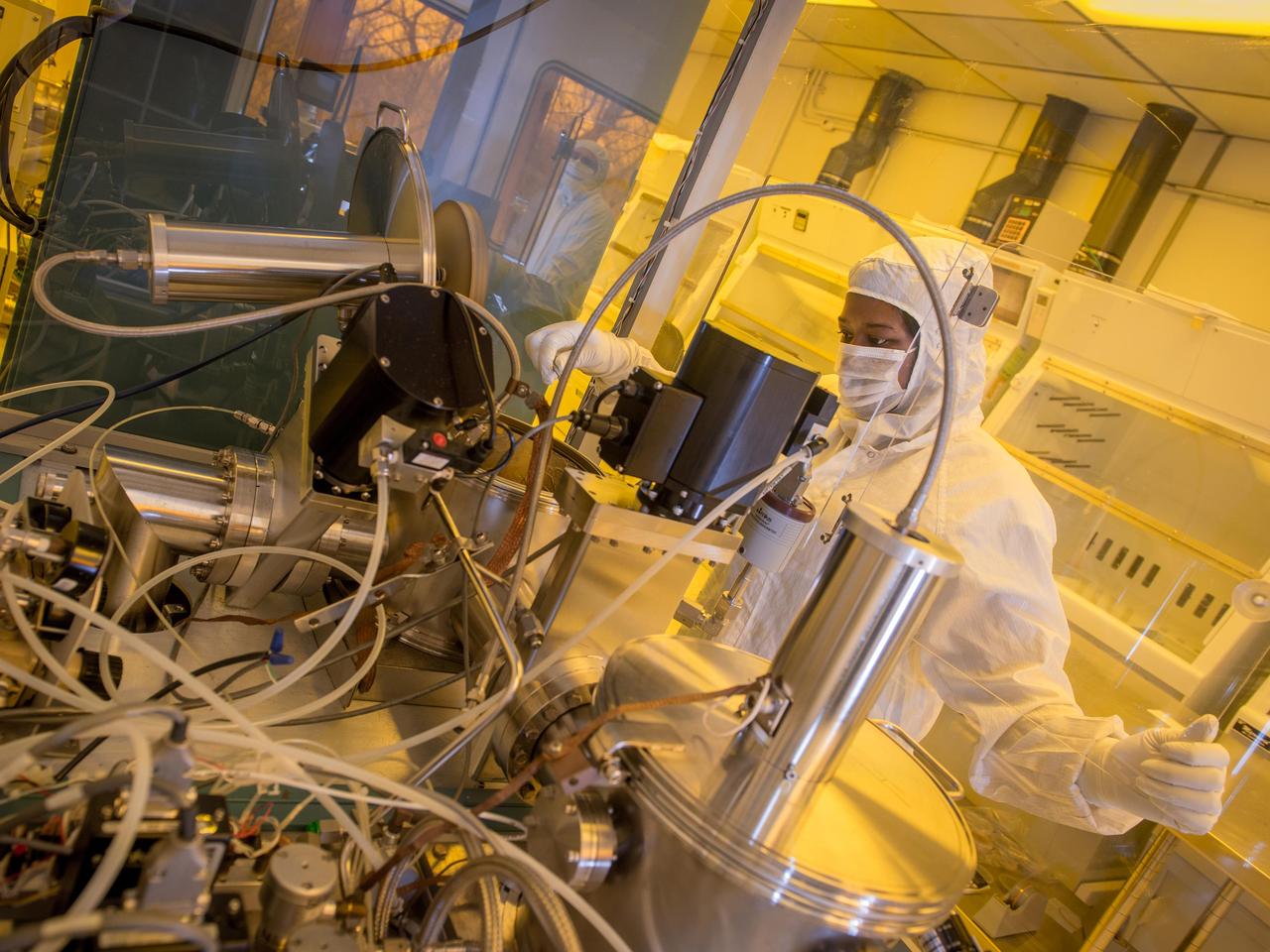NASA Glenn technician Ariana Miller prepares an ultrahigh vacuum chamber used to test the materials used in silicon carbide based sensors and electronics that can operate at extremely high temperatures (500 degrees Celsius and higher) for applications such as sensor systems for aircraft engines and Venus exploration.