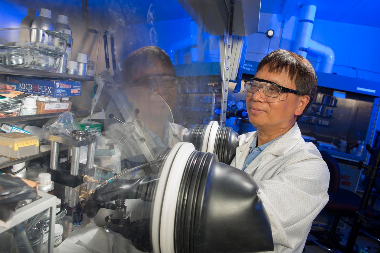 NASA Glenn Researcher James Wu assembles a lithium-metal based battery lab cell incorporating a new solid polymer nanocomposite electrolyte developed at the center.