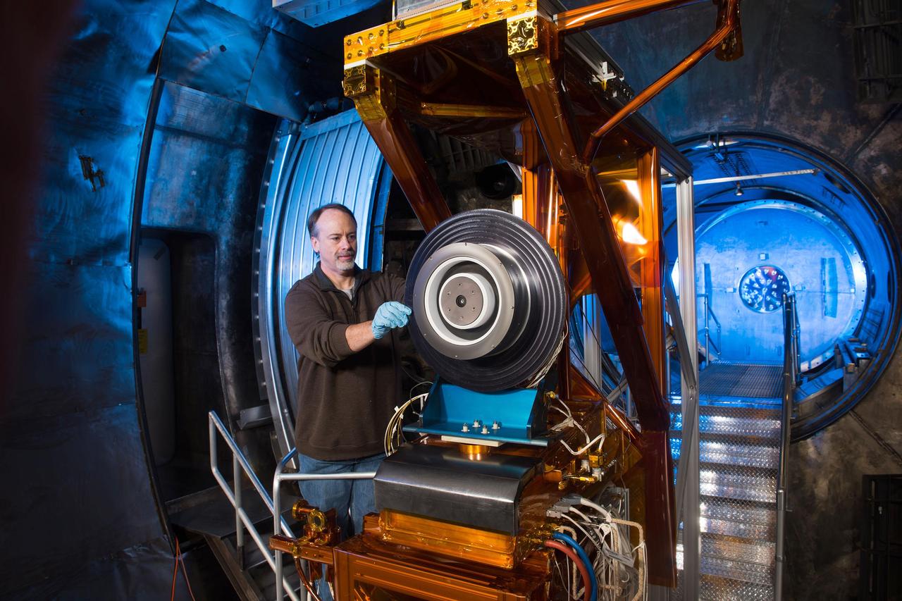 NASA Glenn engineer Dr. Peter Peterson prepares a high-power Hall thruster for ground testing in a vacuum chamber that simulates the environment in space. This high-powered solar electric propulsion thruster has been identified as a critical part of NASA’s future deep space exploration plans.