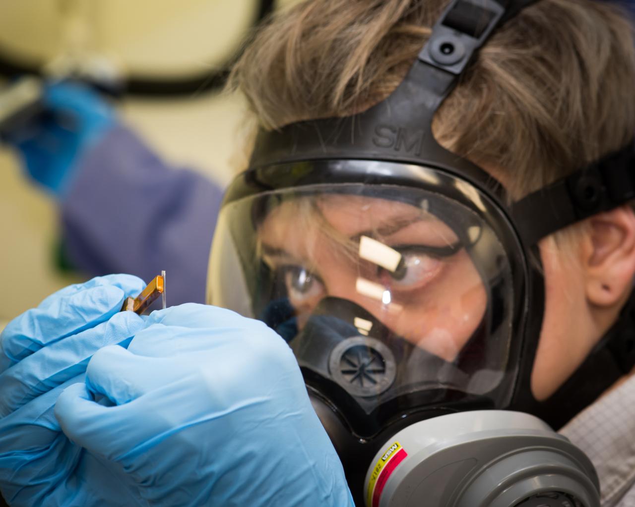 Light Microscopy Modle, LMM, Ground Unit Testing, GU.  Control Systems Engineer using a small magnet to maneuver a 1mm metal stir-bar into a colloid sample fluid-filled capillary.  The capillary tubes of sample fluid will be filled and sealed.  The sample fluid supplied by a Principal Investigator typically contains some hazardous/toxic chemicals that she must ensure will not leak and put the astronauts at risk. On-orbit on the LMM, ‘insitu mixing’ is used, which uses electromagnetic inductors to stimulate the metal stir-bar to mix the fluid within the sealed capillary.