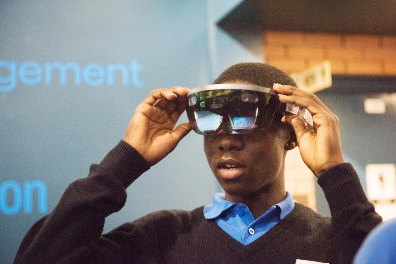 During Avaiation Day, 2018, a Participant uses a Microsoft HoloLens Virtual Reality Headset to view a NASA Created Immersive Visualization