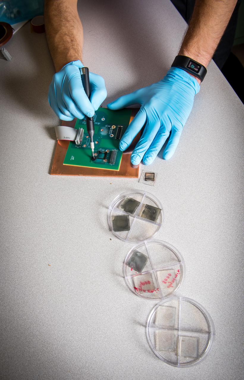 NASA Glenn researcher Tim Peshek shows off a new type of ultrathin solar cell, known as a ‘perovskite’ because of its structure. These solar cells show promise for space applications because of their high efficiency and radiation tolerance and open the door to extremely low cost and large solar arrays for spacecraft or lunar surface habitats.